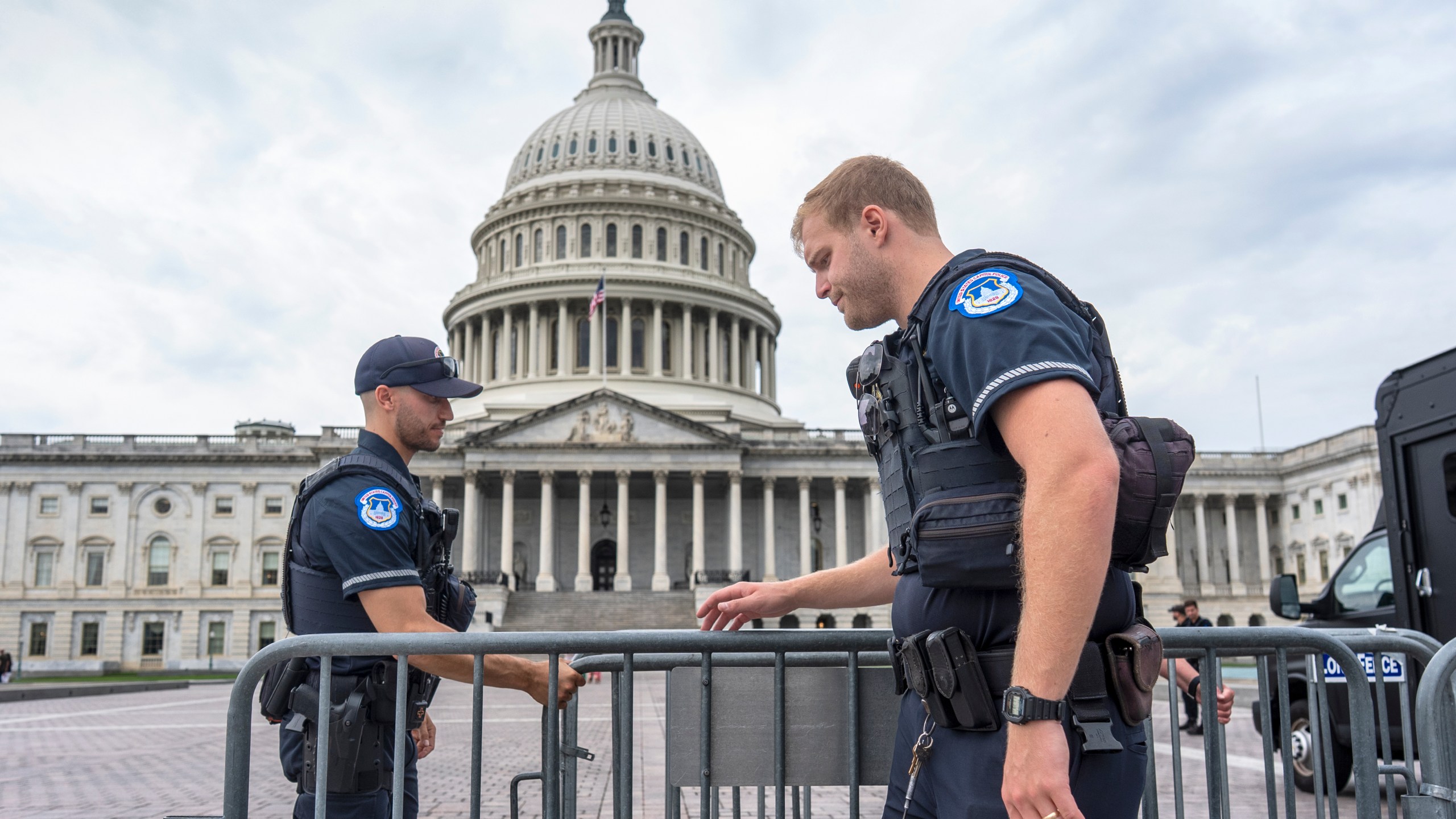 Capitol Police officers adjust security barriers around the East Plaza at the Capitol in Washington, Wednesday, Sept. 24, 2025. With just days to go before federal money runs out with the end of the fiscal year on Tuesday, Sept. 30, Congress has failed to pass legislation to keep the government running after becoming deadlocked during votes late last week. (AP Photo/J. Scott Applewhite)