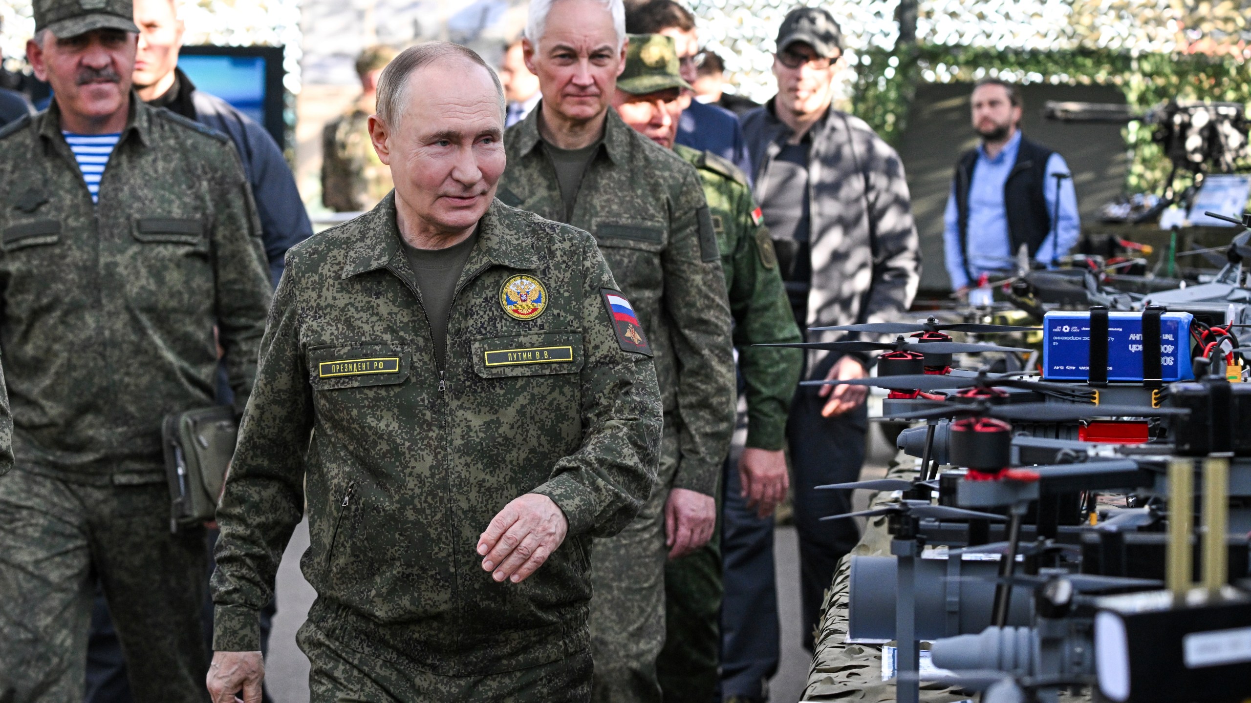 CORRECTS SOURCE FOR POOL - Russian President Vladimir Putin, accompanied by Deputy Defense Minister Yunus-Bek Yevkurov, left, and Defense Minister Andrei Belousov, right, inspects weapons and equipment during a visit to the "Zapad 2025" ("West 2025") military drills at the Mulino training ground in the Nizhny Novgorod region, Russia, Tuesday, Sept. 16, 2025. (Sergey Bobylev/Sputnik, Kremlin Pool Photo via AP)