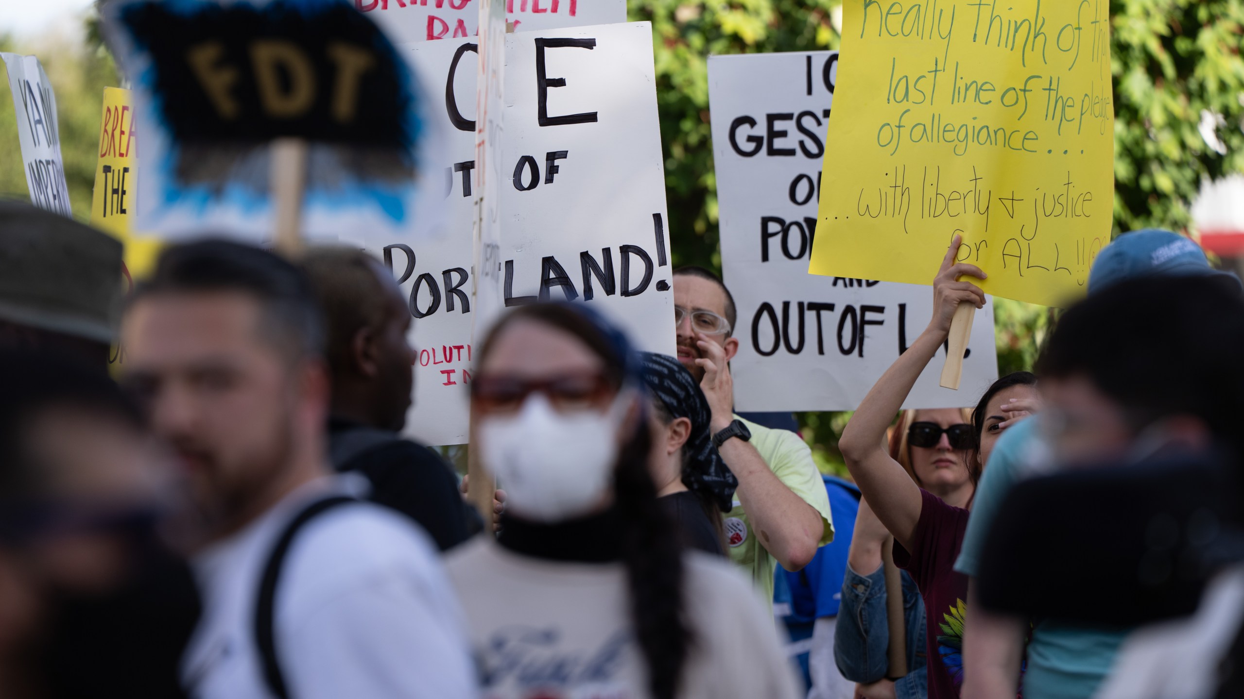 People protest outside a U.S. Immigration and Customs Enforcement facility on Sunday, Sept. 28, 2025, in Portland, Ore. (AP Photo/Jenny Kane)