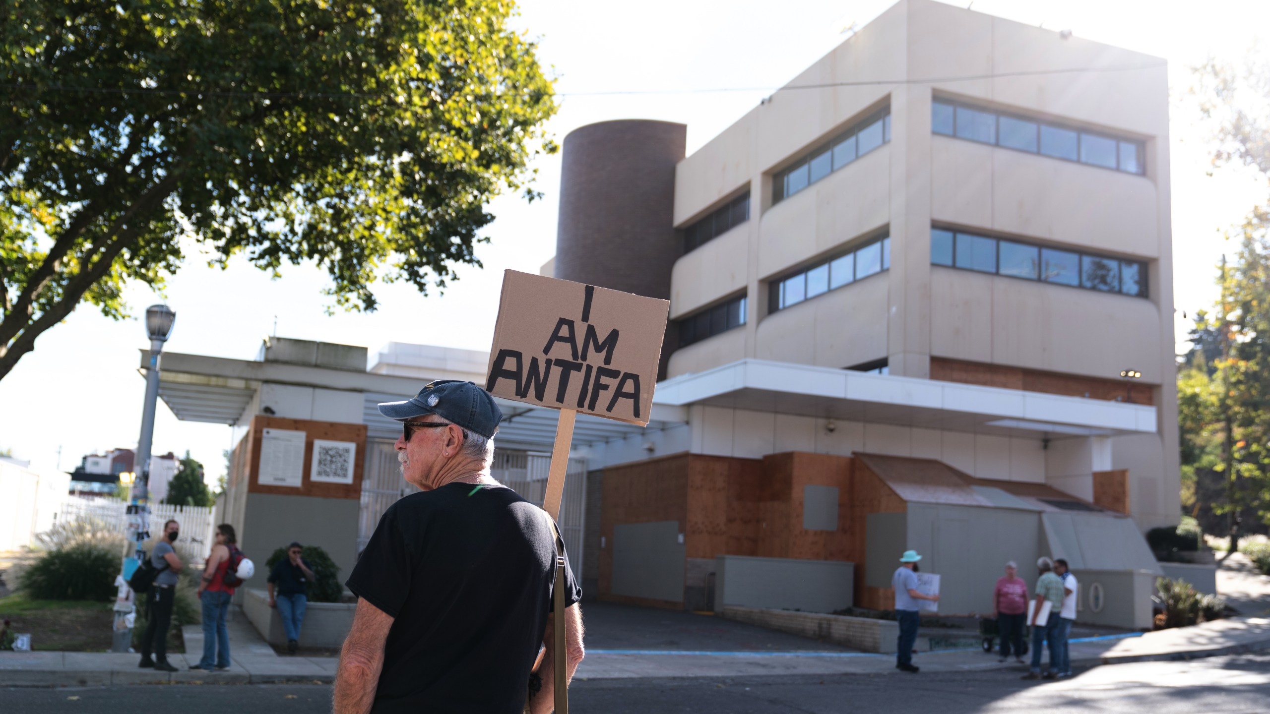 People protest outside a U.S. Immigration and Customs Enforcement facility on Sunday, Sept. 28, 2025, in Portland, Ore. (AP Photo/Jenny Kane)