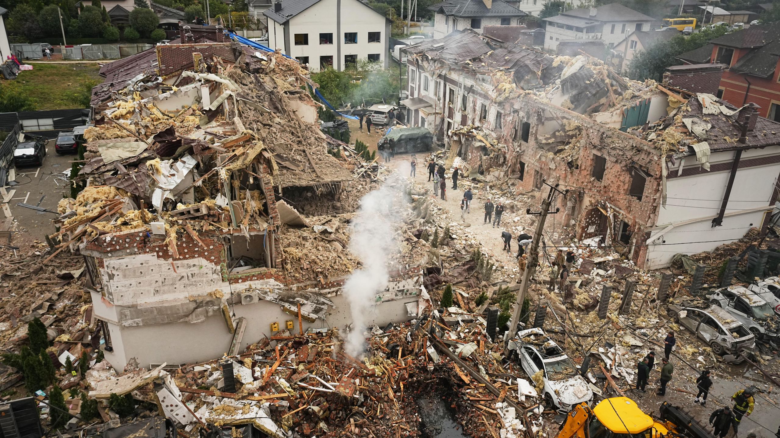Rescuers work at the site of an apartment buildings damaged during a Russian attack in Kyiv, Ukraine, Sunday, Sept. 28, 2025. (AP Photo/Efrem Lukatsky)