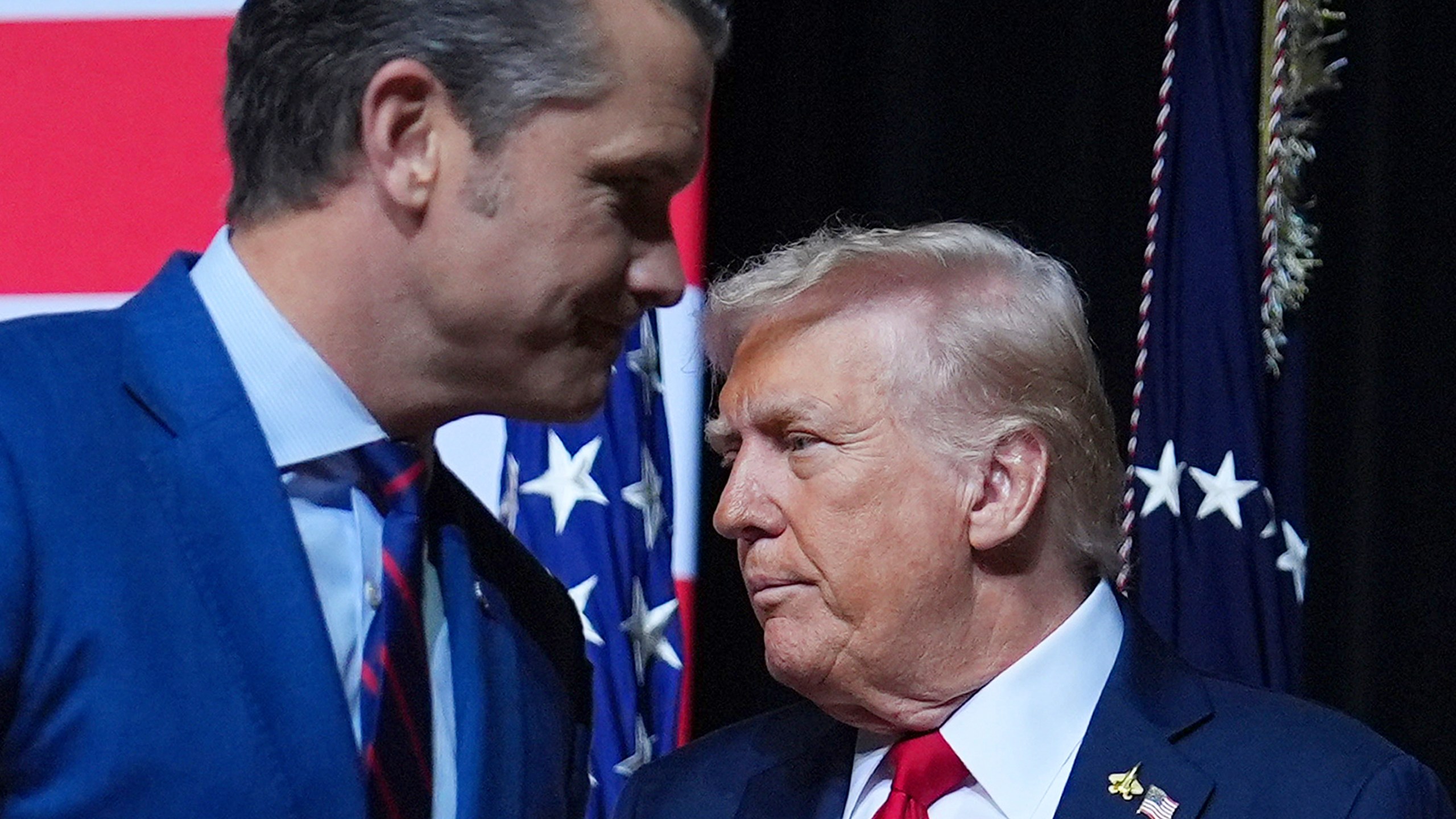 President Donald Trump is greeted by Secretary of Defense Pete Hegseth before speaking to a gathering of top U.S. military commanders at Marine Corps Base Quantico, Tuesday, Sept. 30, 2025, in Quantico, Va. (AP Photo/Evan Vucci)