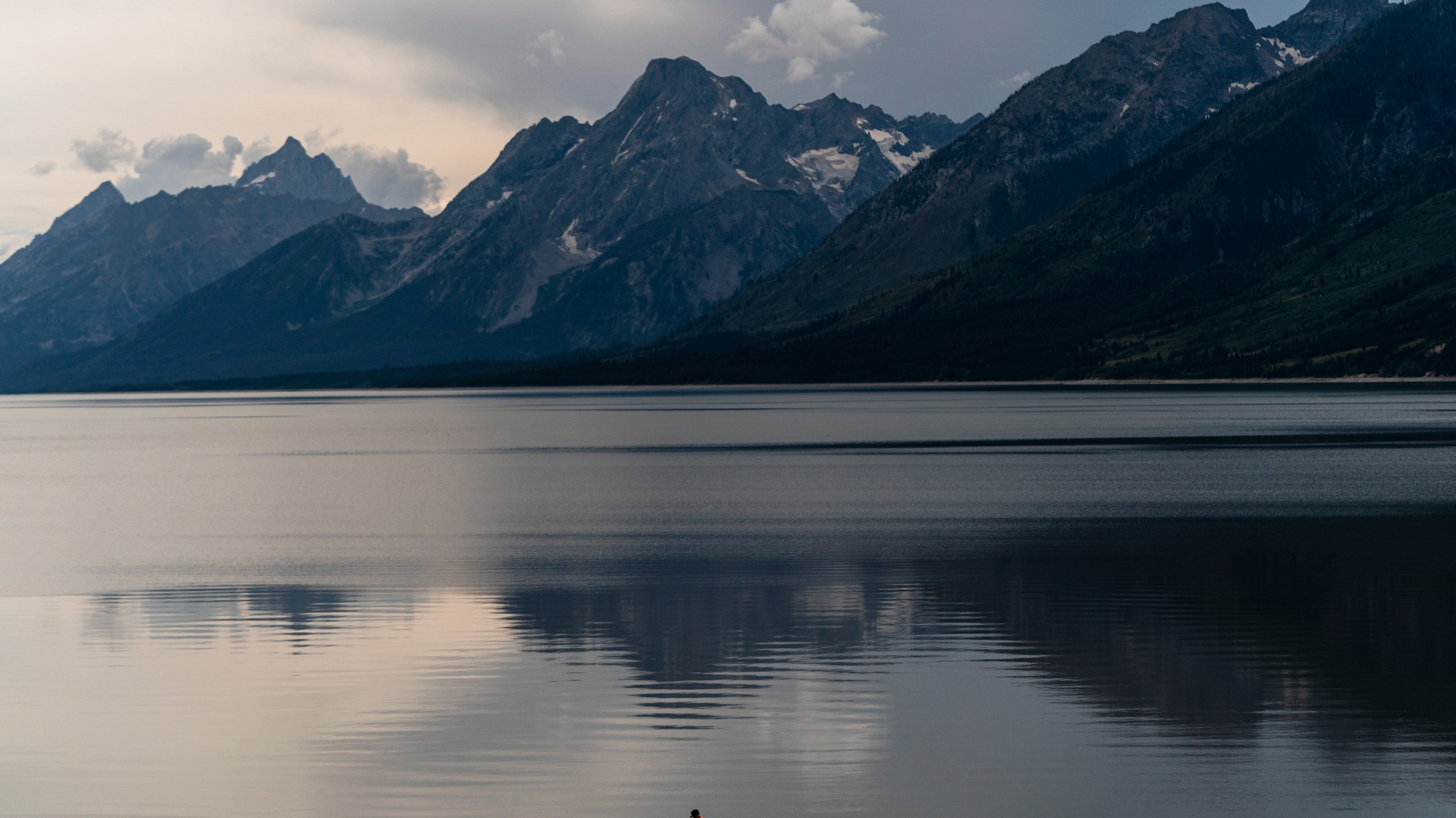 Jack Scieszka, 14, walks along Jackson Lake in Grand Teton National Park, Wyo, Saturday, Aug. 13, 2022. (AP Photo/Jae C. Hong)