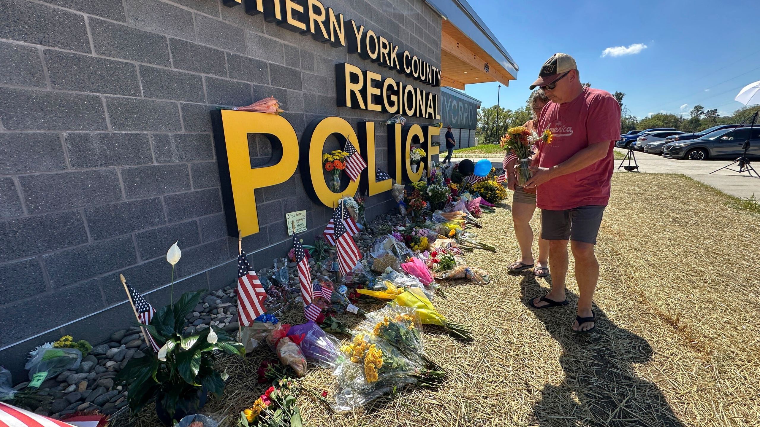 A memorial for police officers killed in a shooting is shown outside the Northern York County Regional Police Department