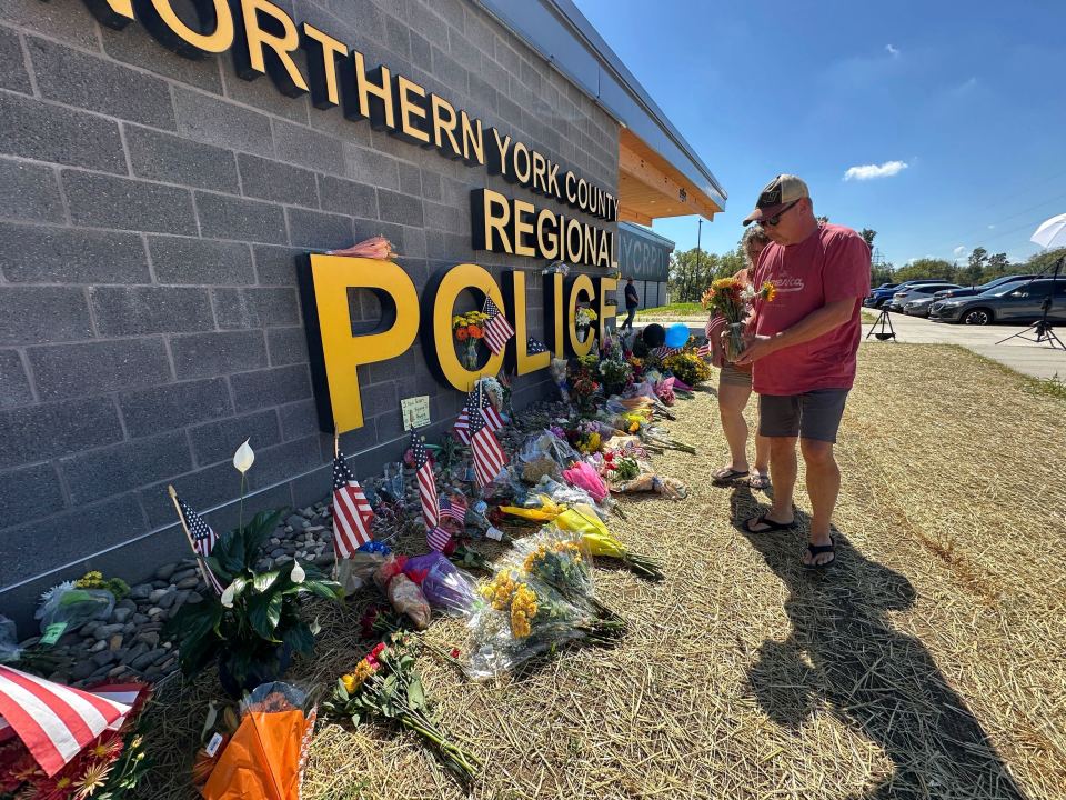 A memorial for police officers killed in a shooting is shown outside the Northern York County Regional Police Department