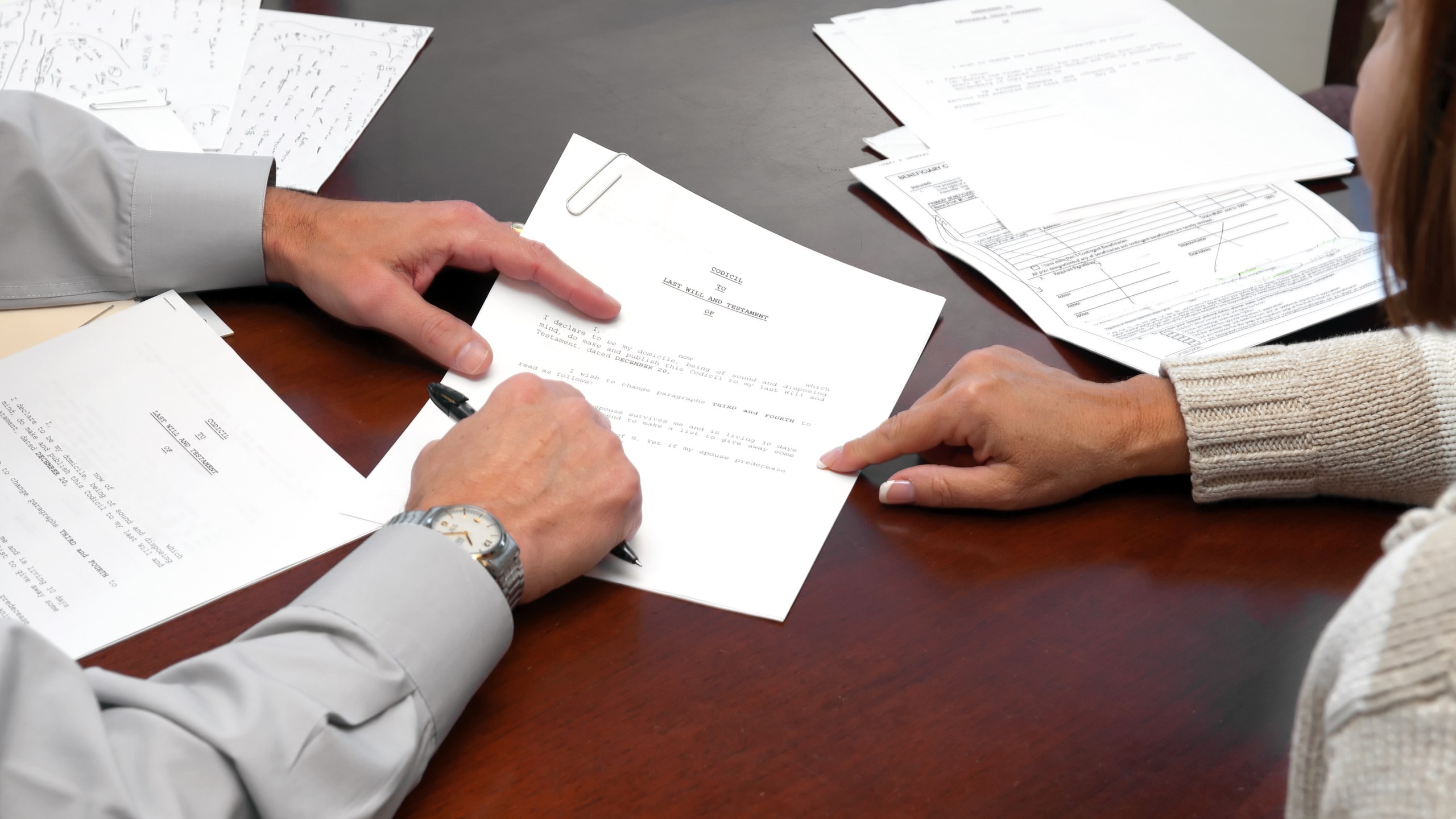 A woman making a formal business agreement signing a will