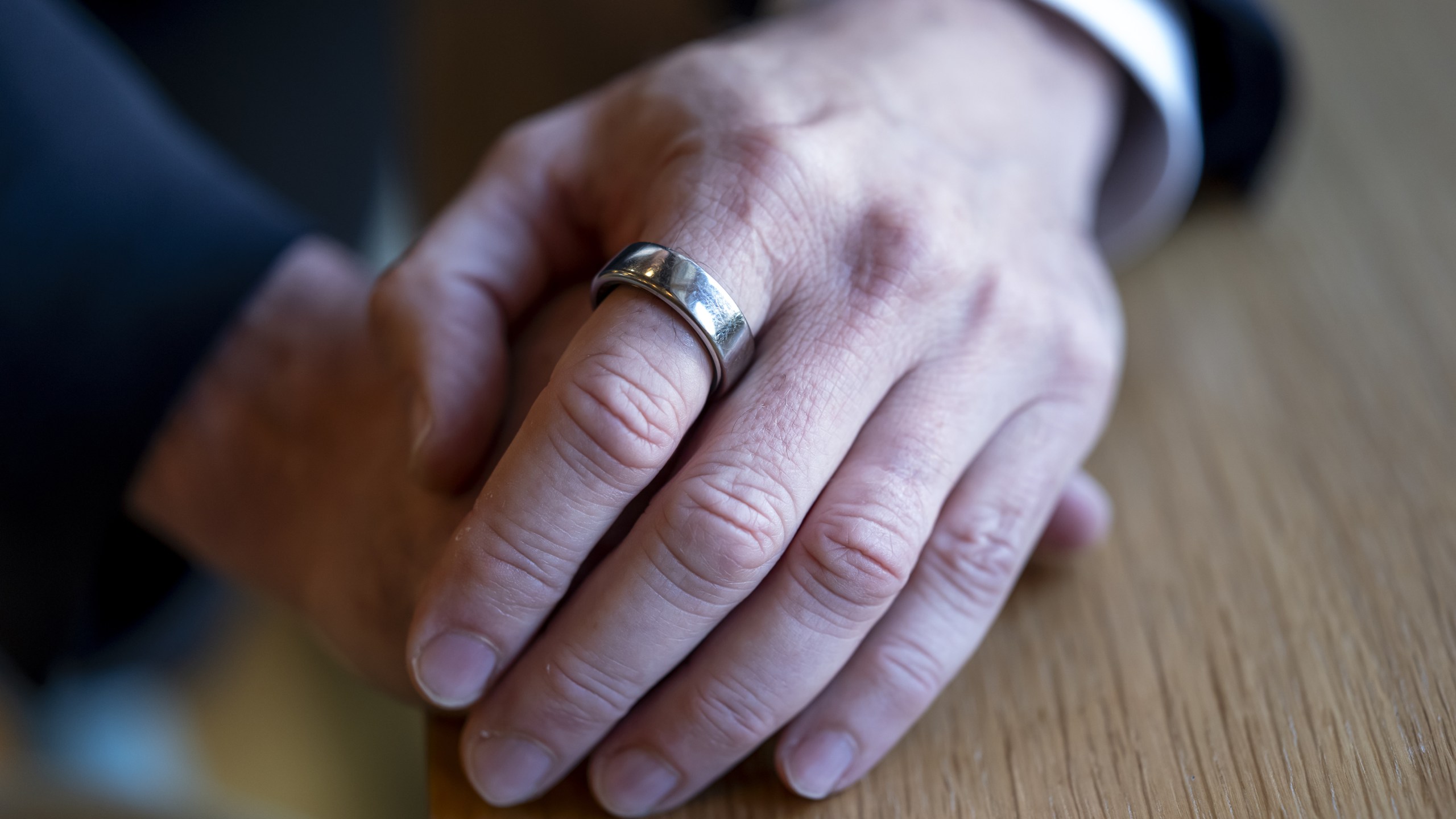 Oura ring on index finger of hand