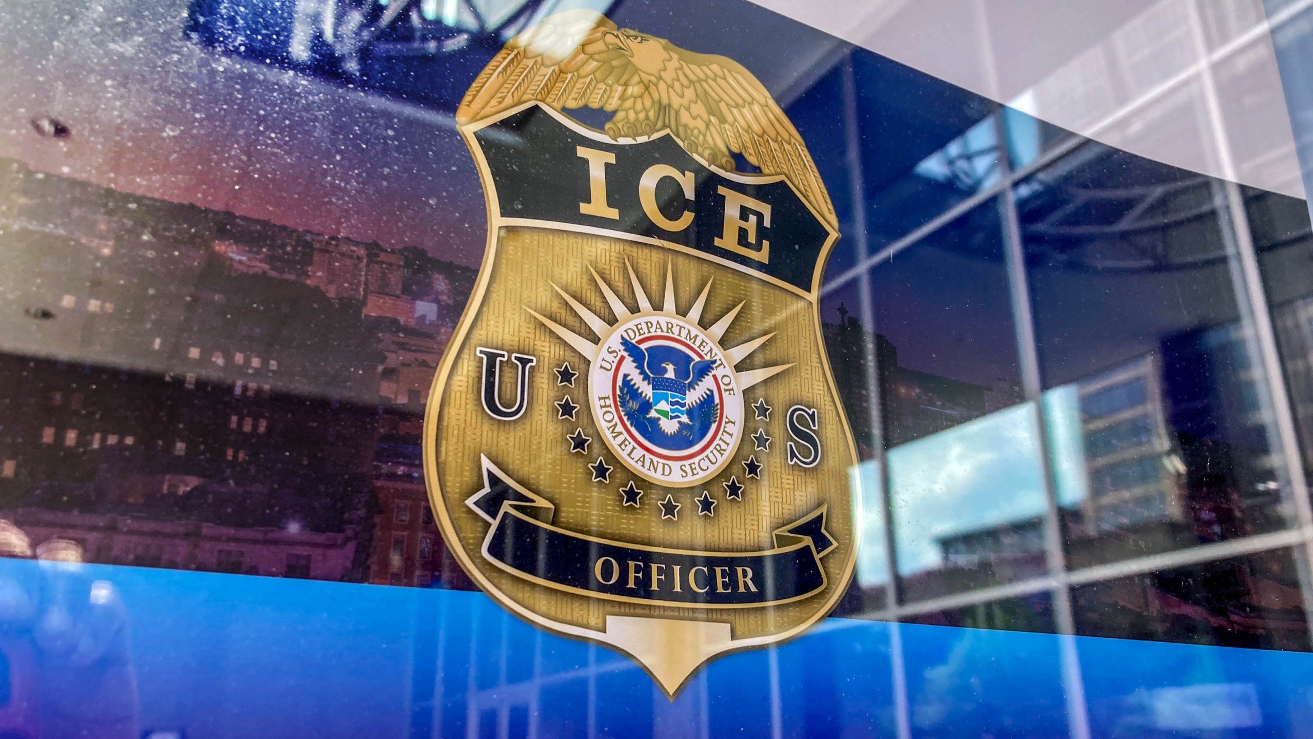 An ICE officer badge logo