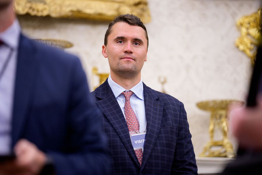 Turning Point USA co-founder Charlie Kirk stands in the back of the room as U.S. President Donald Trump speaks during a swearing in ceremony for interim U.S. Attorney for Washington, D.C. Jeanine Pirro in the Oval Office of the White House on May 28, 2025 in Washington, DC. Trump has announced Pirro, a former Fox News personality, judge, prosecutor, and politician, after losing support in the Senate for his first choice, Ed Martin, over his views on the January 6, 2021 attack on the U.S. Capitol