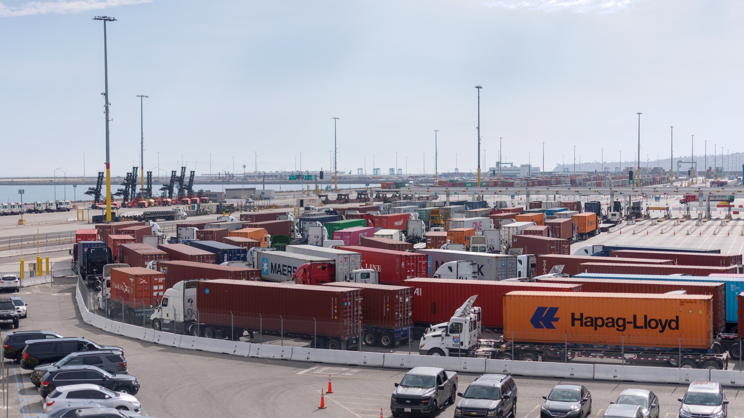 Tractor trailers carrying shipping containers