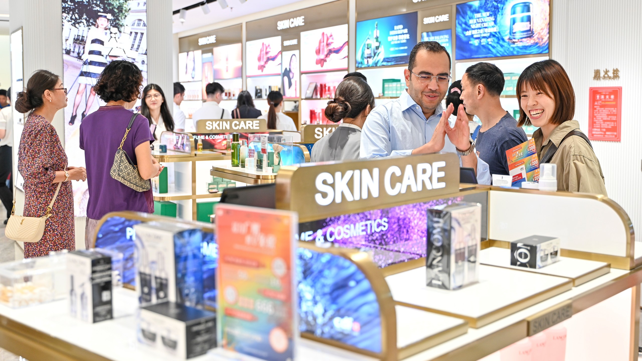 Consumers select skin care products at a beauty store