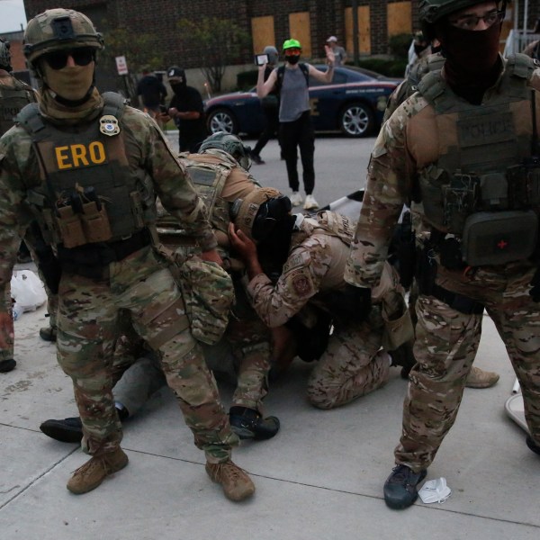 Immigration and Customs Enforcement (ICE), Special Response Team Police and Enforcement and Removal Operations (ERO) agents detain a demonstrator during a protest outside an ICE processing center in Broadview, Illinois, on September 19, 2025. US President Donald Trump ordered increased federal law enforcement presence in Illinois and stepped-up immigration enforcement actions by the Department of Homeland Security. (Photo by OCTAVIO JONES / AFP) (Photo by OCTAVIO JONES/AFP via Getty Images)