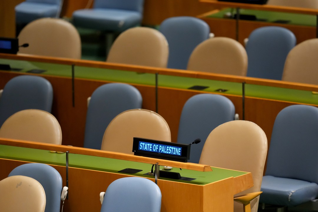 A State of Palestine sign in front of empty seats