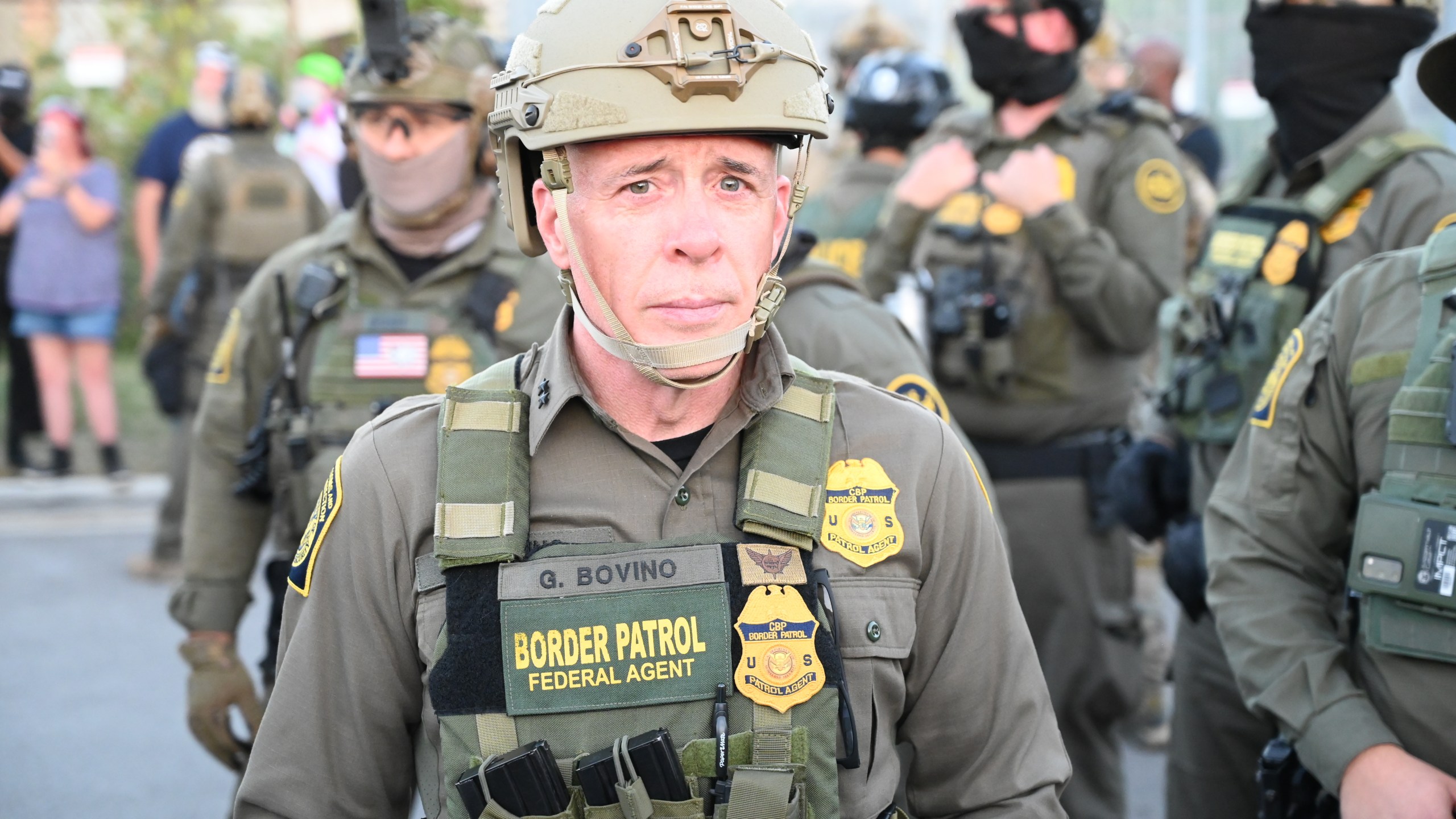 Border Patrol Chief Gregory Bovino of the El Centro Sector stands amid a protest