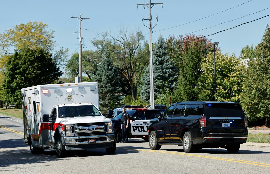 Police and emergency vehicles respond near the scene of a shooting at a church in Grand Blanc, Michigan, on September 28, 2025. One person was killed and several others injured Sunday after a shooter targeted a Mormon church in the US state of Michigan, where the building was also set on fire, authorities said. The suspect, a 40-year-old man from a nearby town, was shot dead by law enforcement after the attack, police said, without specifying any possible motive. (Photo by Jeff Kowalsky / AFP) (Photo by JEFF KOWALSKY/AFP via Getty Images)