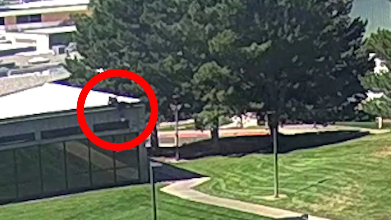 A person of interest in Charlie Kirk's shooting death is seen jumping off the roof of a building