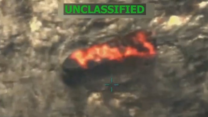 A boat is seen on fire after a strike by the US military near Venezuela