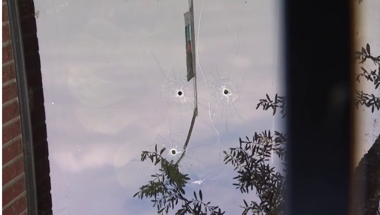 bullet holes in glass door
