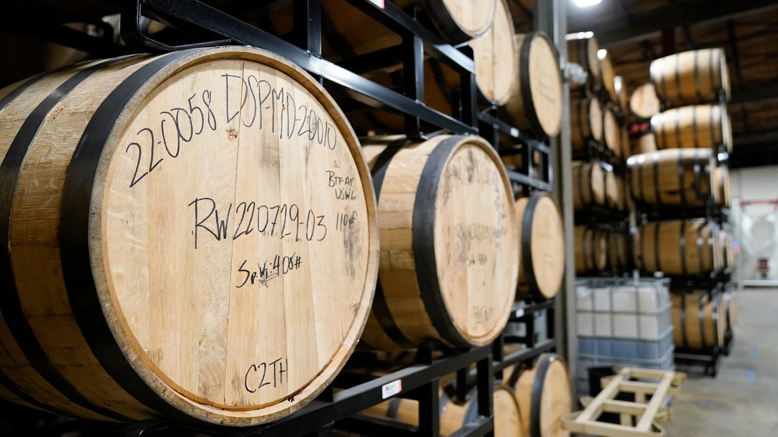 FILE - Barrels of spirits are seen at the Baltimore Spirits Company distillery, Feb. 8, 2023, in Baltimore. (AP Photo/Julio Cortez, file)