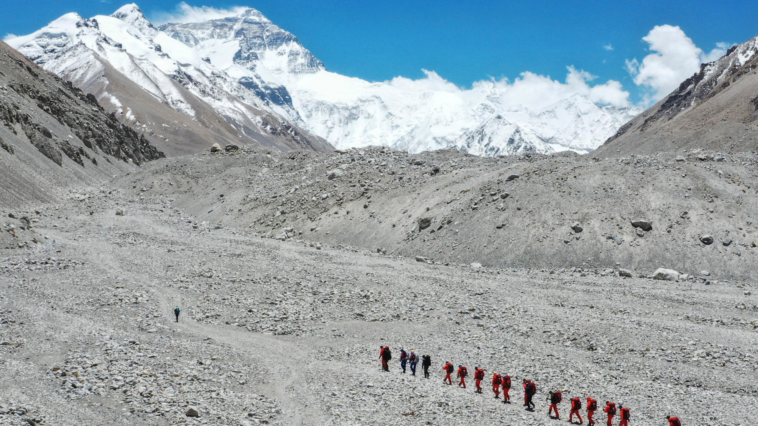 FILE - In this May 16, 2020 aerial photo released by Xinhua News Agency, Chinese surveyors hike toward a higher spot from the base camp on Mount Qomolangma at an altitude of 5,200 meters. (Jigme Dorje/Xinhua via AP, File)
