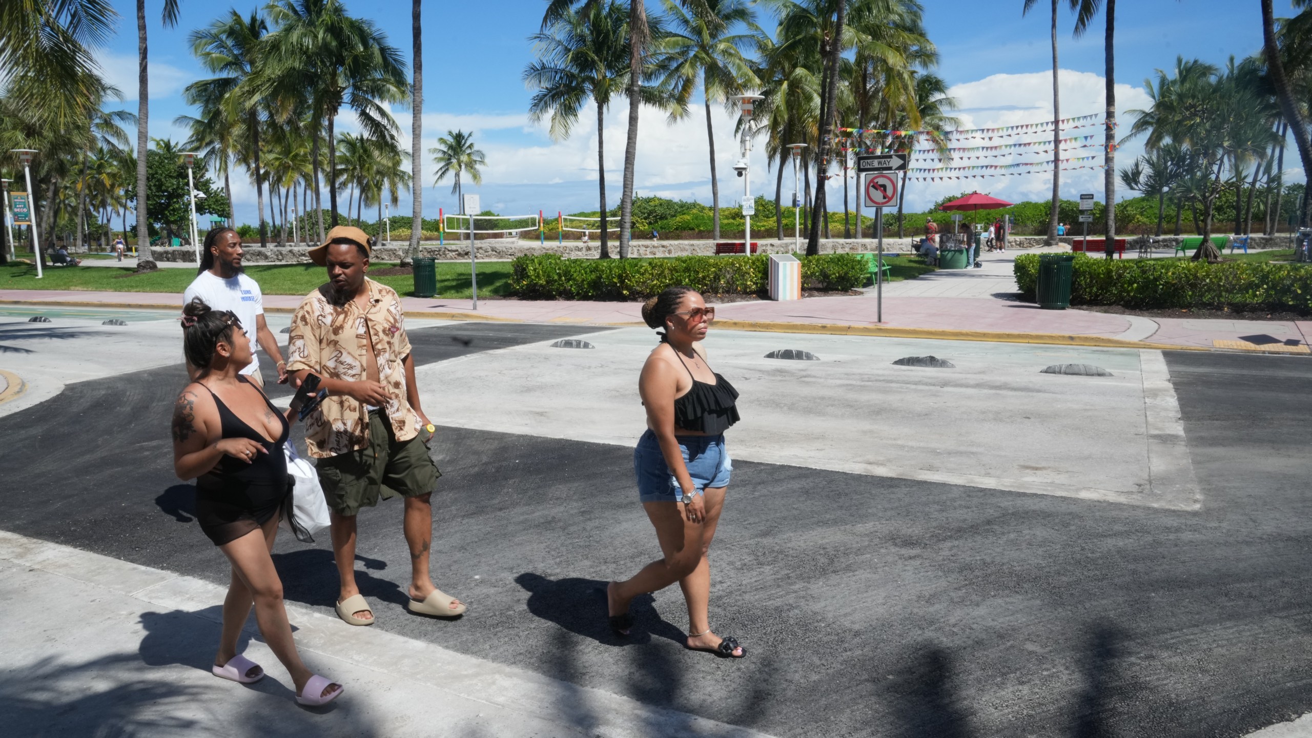 Pedestrians walk over a crosswalk on Miami Beach's iconic Ocean Drive that used to be rainbow-colored celebrating the history and contributions of the LGBTQ+ community, Monday, Oct. 6, 2025. (AP Photo/Marta Lavandier)