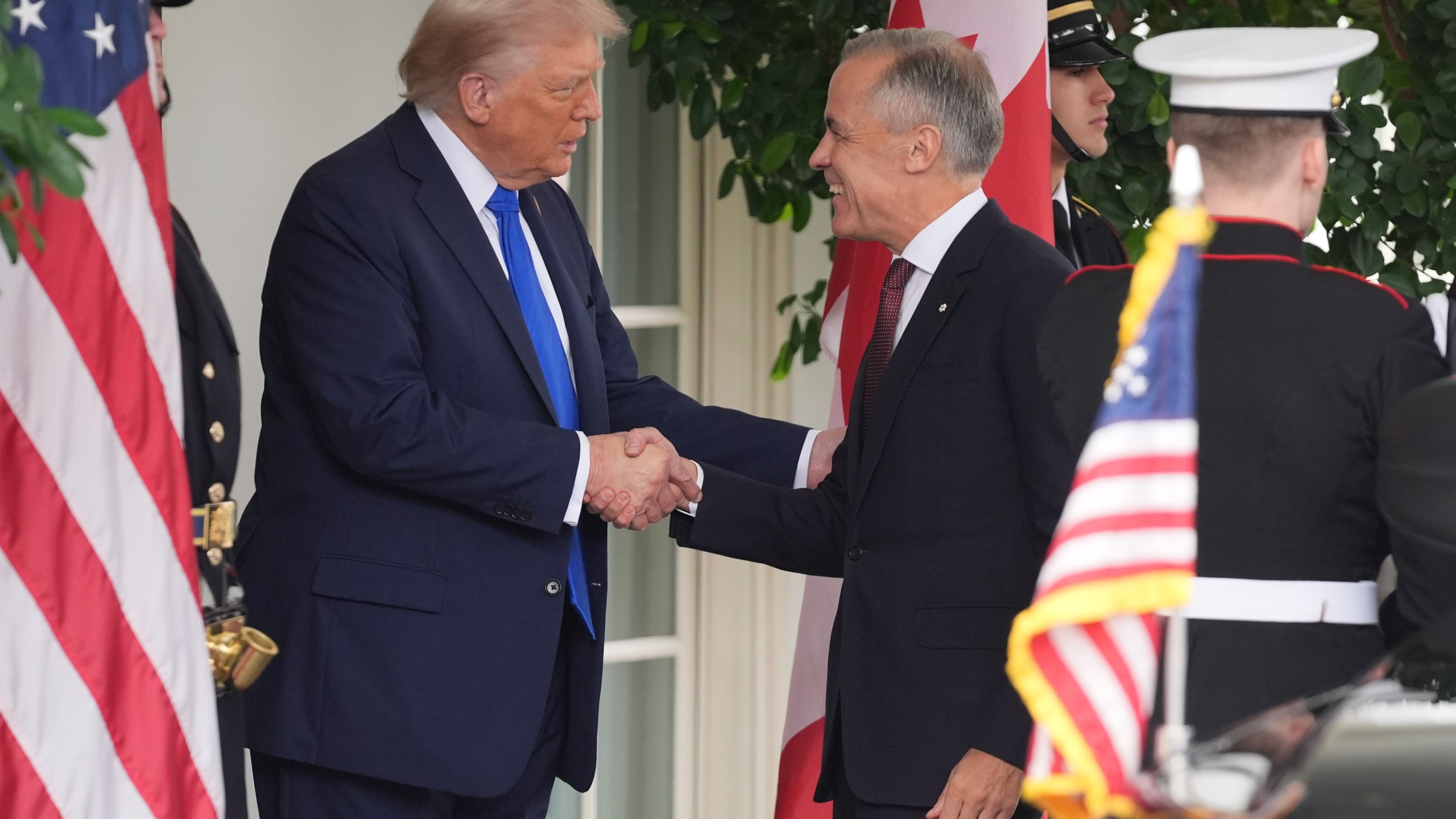 President Donald Trump greets Canadian Prime Minister Mark Carney at the White House, Tuesday, Oct. 7, 2025, in Washington. (AP Photo/Evan Vucci)