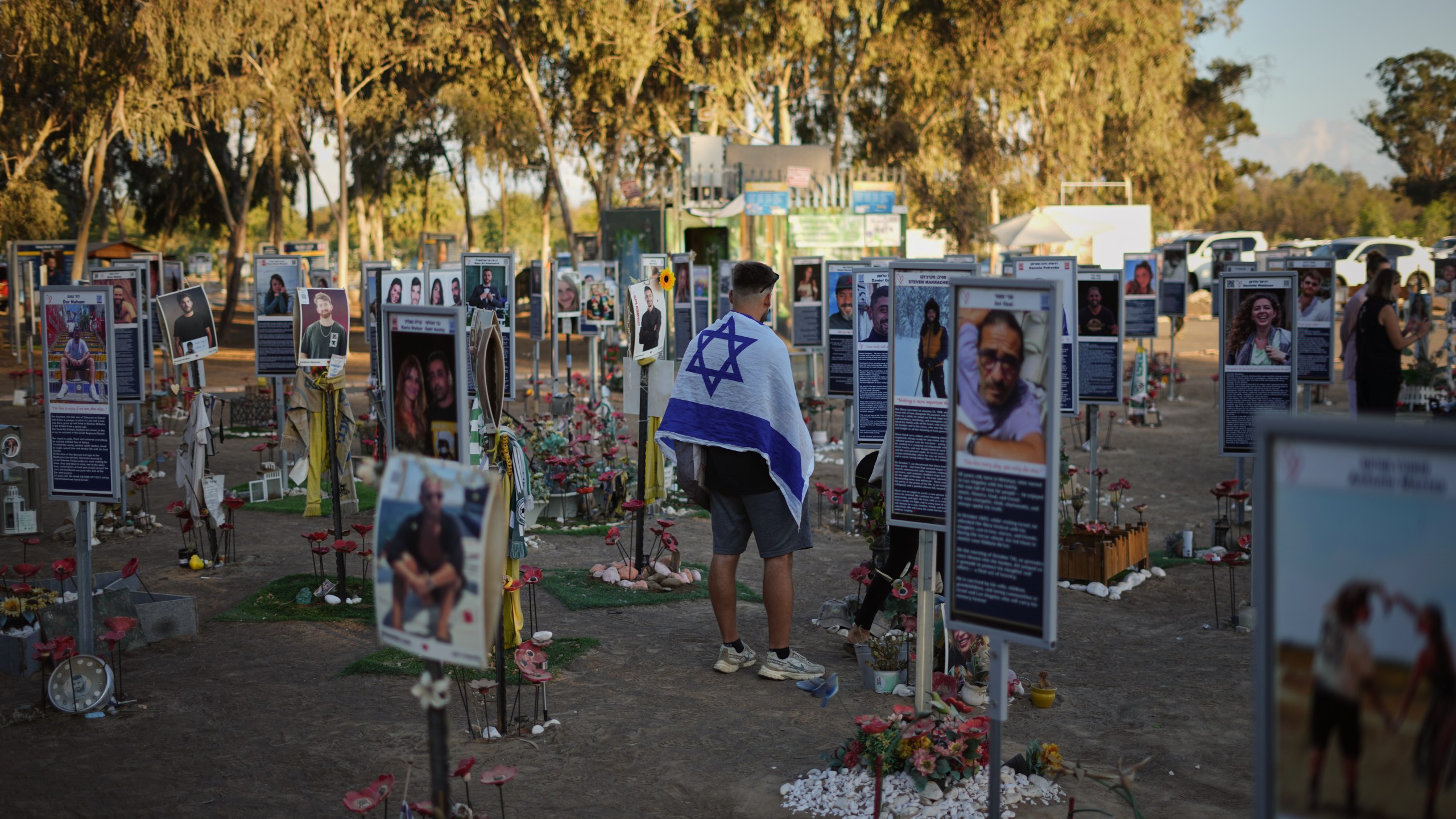 People visit the site of the Nova music festival, where hundreds of revelers were killed and abducted by Hamas and taken into Gaza, as Israel marks the second year anniversary of the attack, near Kibbutz Reim, southern Israel, Tuesday, Oct. 7, 2025. (AP Photo/Ariel Schalit)