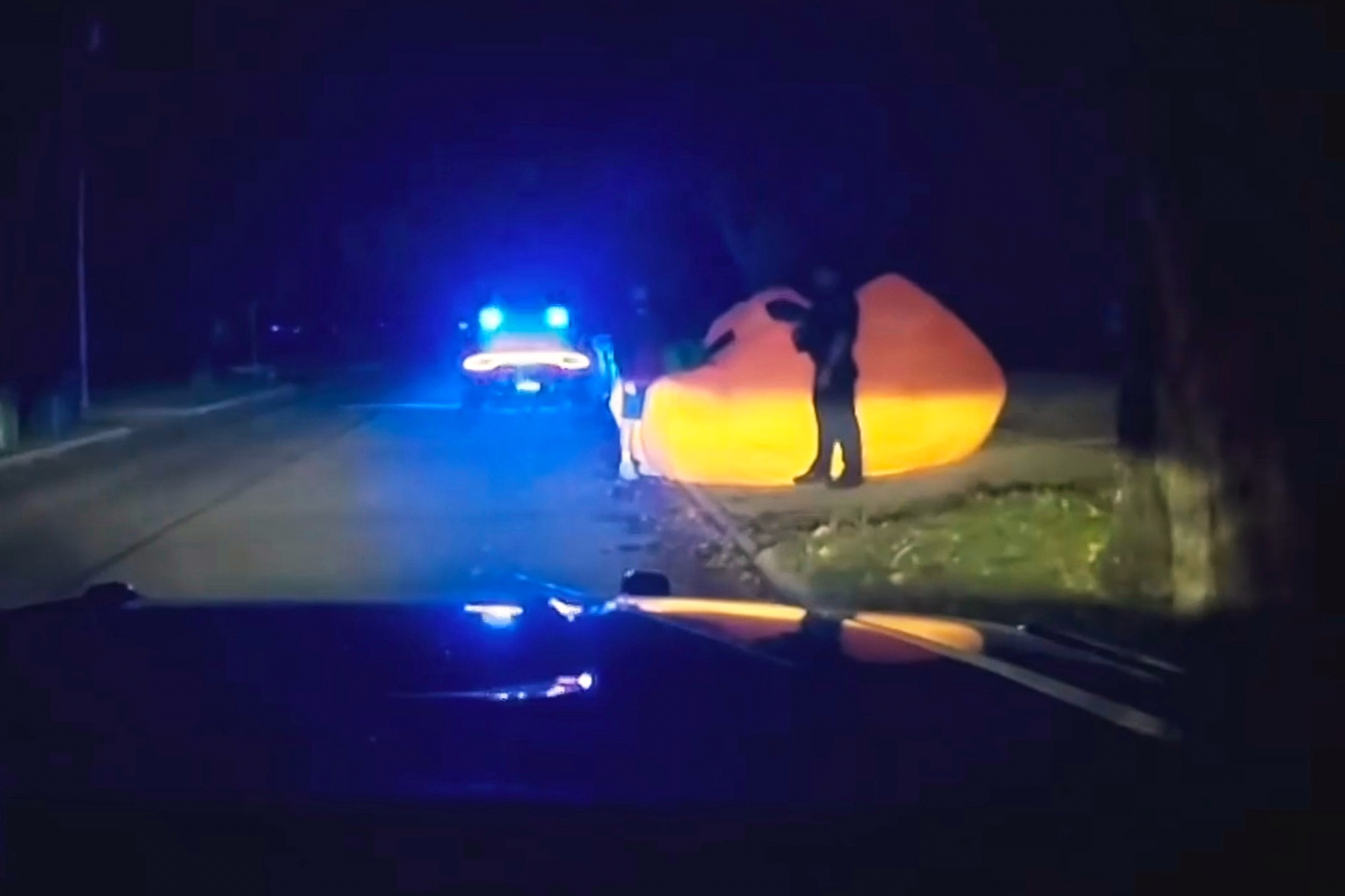 This image made from a Parma Heights Police Department body camera video shows a police officer approaching a runaway inflatable pumpkin on Tuesday, Oct. 7, 2025. (Parma Heights Police Department via AP)