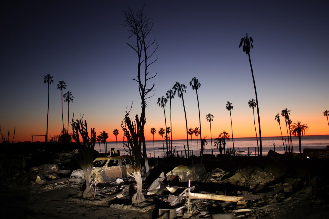 FILE - The devastation of the Palisades Fire is seen at sunset in the Pacific Palisades neighborhood of Los Angeles, Jan. 14, 2025. (AP Photo/Ethan Swope, file)