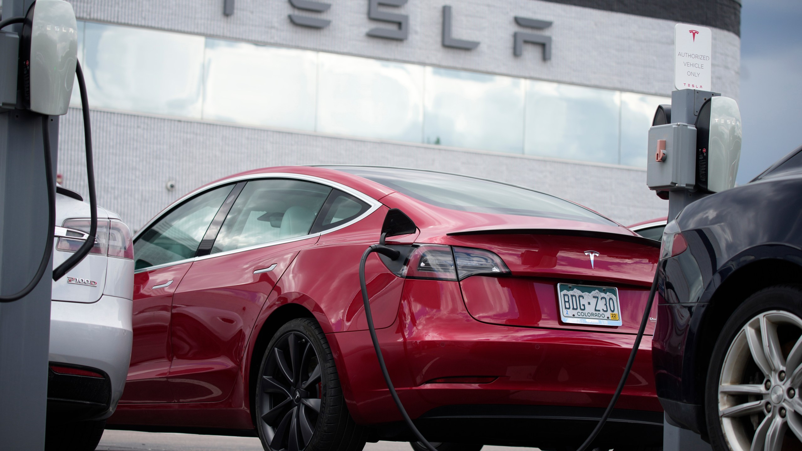 FILE - A 2021 Model 3 sedan sits in a near-empty lot at a Tesla dealership in Littleton, Colo. June 27, 2021. (AP Photo/David Zalubowski, File)