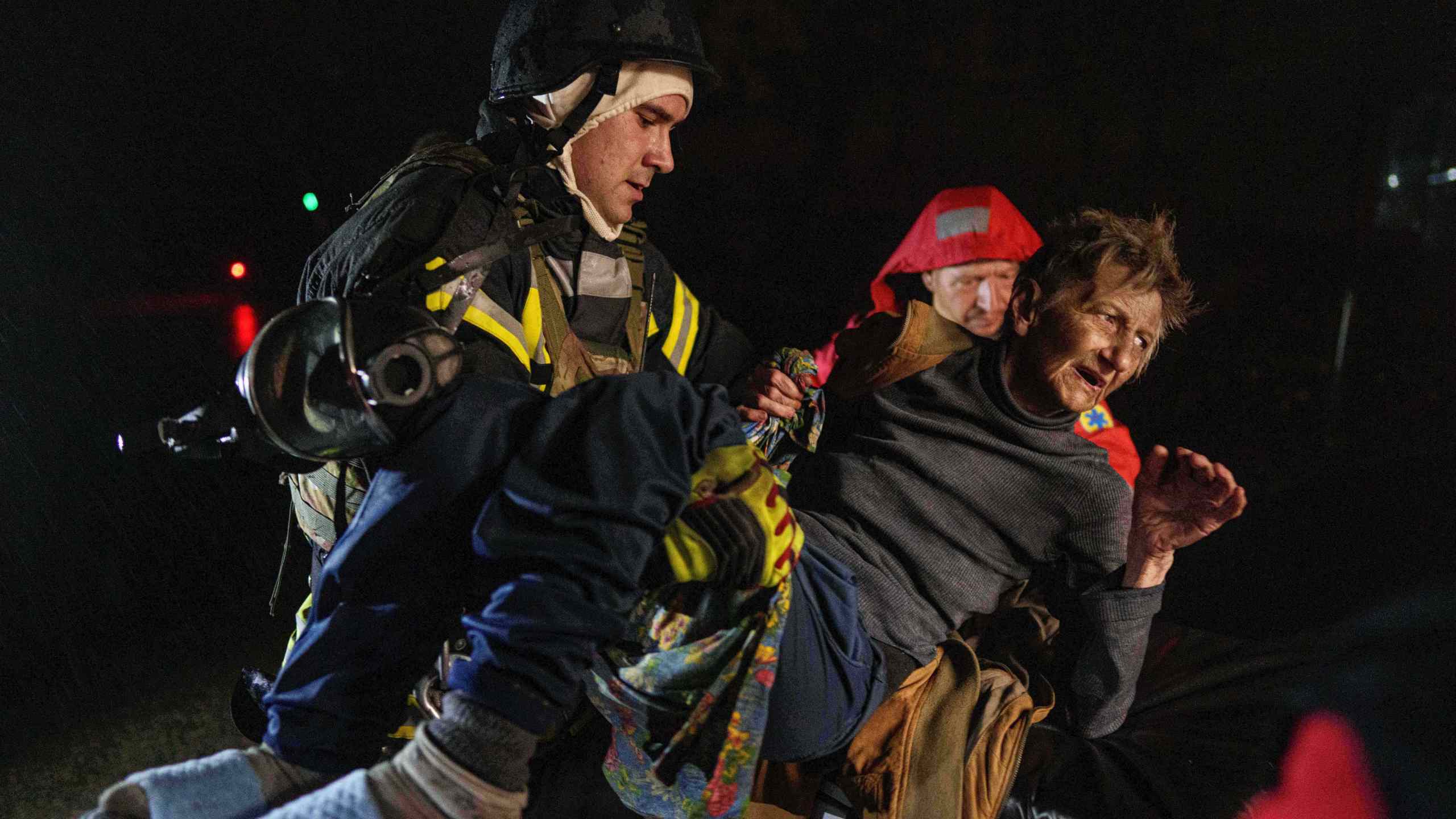 Rescuers carry an injured woman into an ambulance after a Russian strike on a residential neighborhood in Kyiv, Ukraine, on Friday, Oct. 10, 2025. (AP Photo/Evgeniy Maloletka)