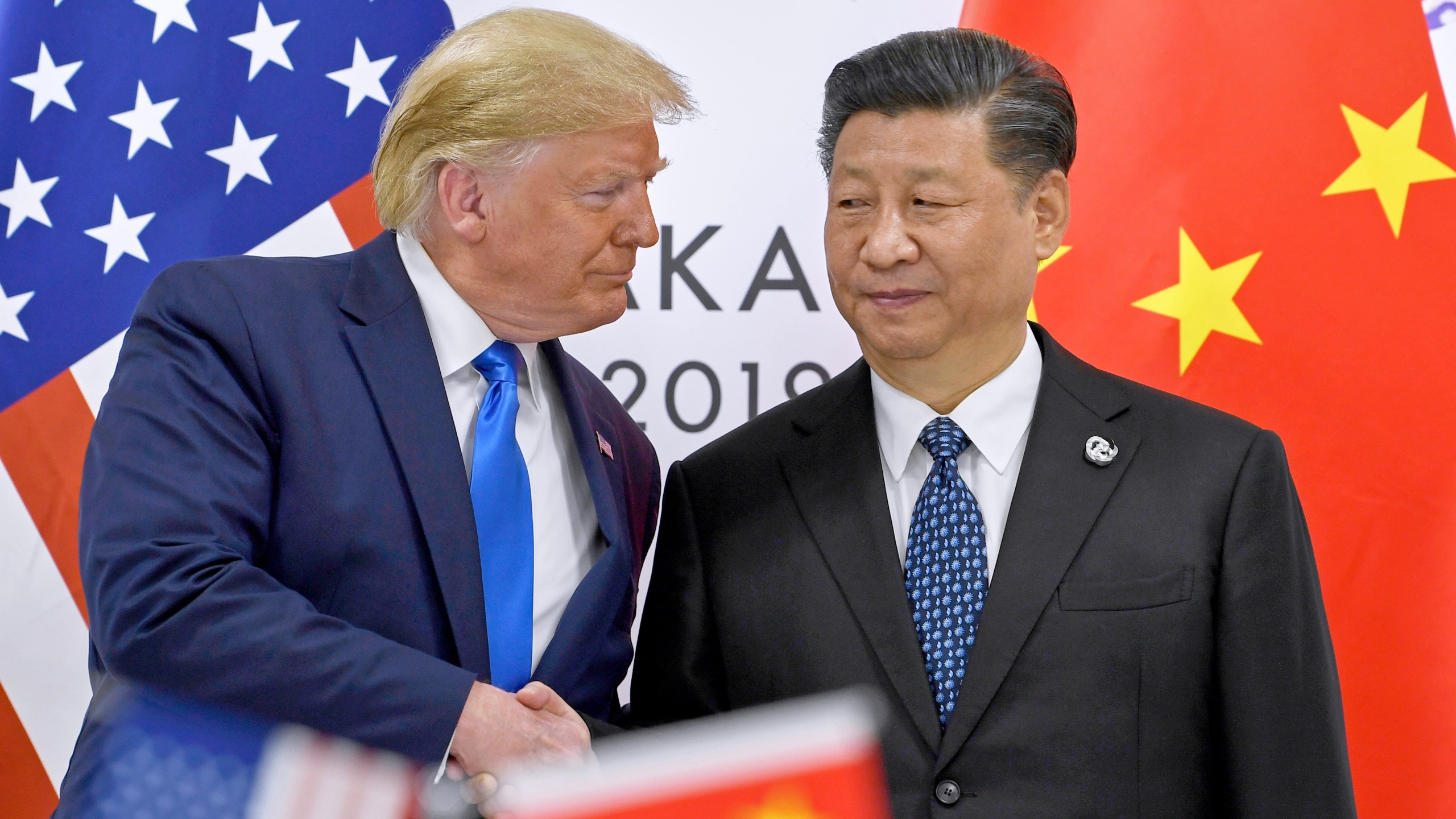 FILE - U.S. President Donald Trump, left, shakes hands with Chinese President Xi Jinping during a meeting on the sidelines of the G-20 summit in Osaka, western Japan, June 29, 2019. (AP Photo/Susan Walsh, File)