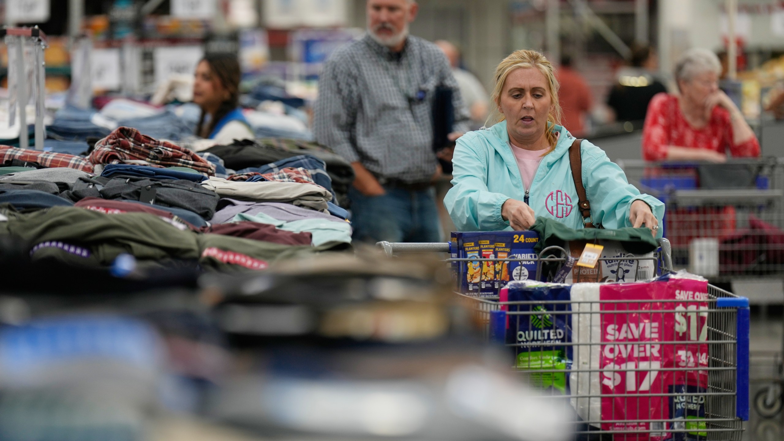 People shop for clothing at a Sam's Club, Wednesday, Sept. 24, 2025, in Bentonville, Ark. (AP Photo/Charlie Riedel)