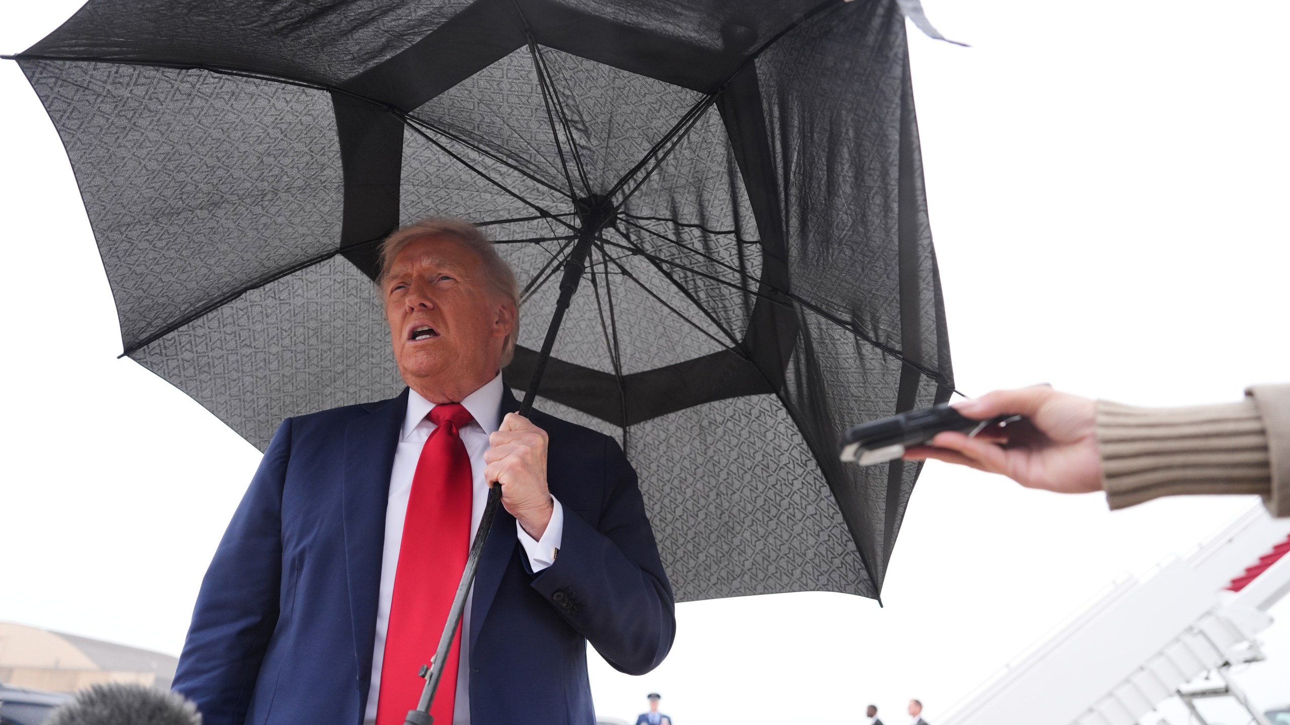 President Donald Trump speaks with reporters before boarding Air Force One, Sunday, Oct. 12, 2025, at Joint Base Andrews, Md., as he heads to the Middle East. (AP Photo/Evan Vucci)
