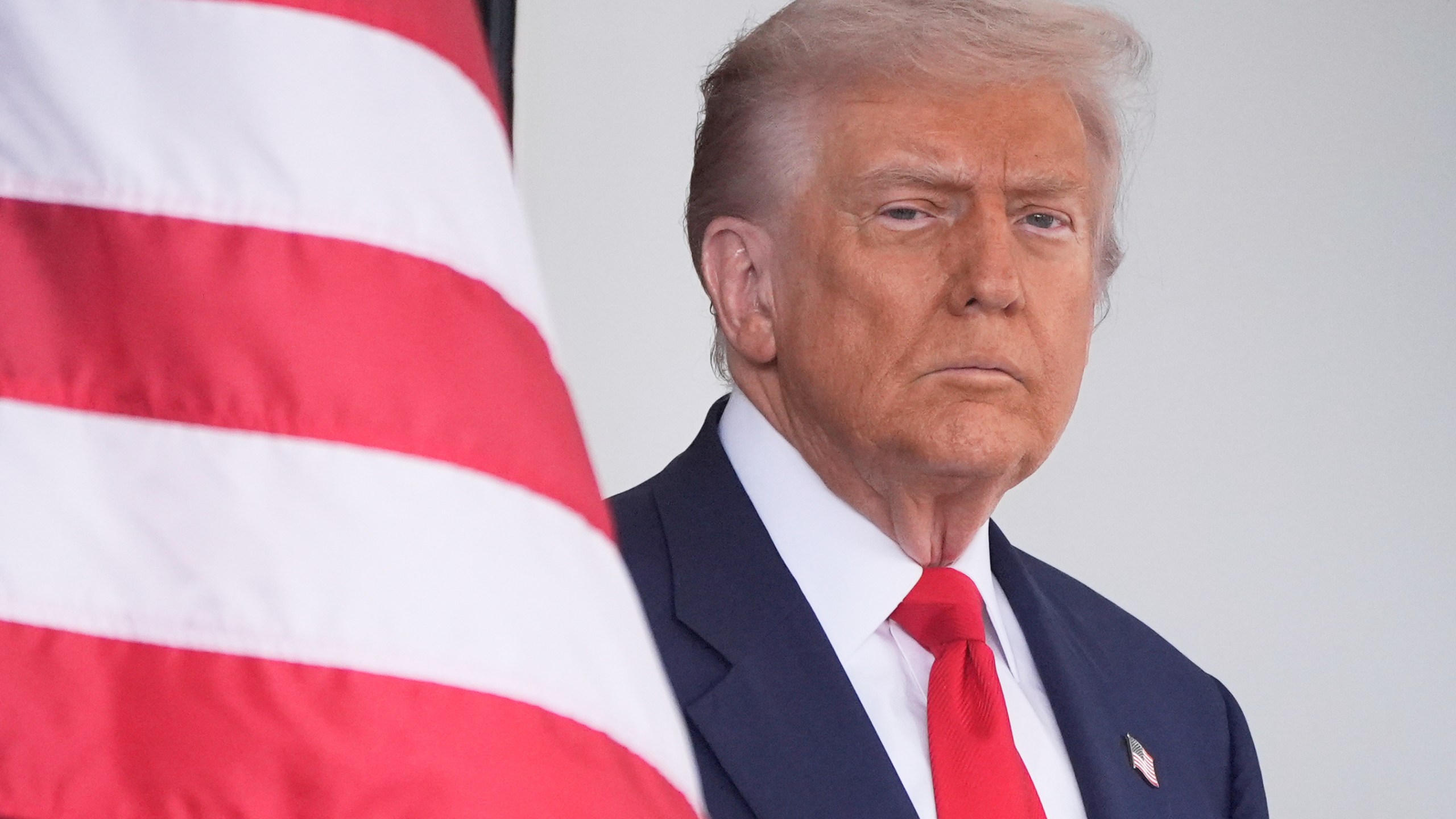 President Donald Trump waits to greet Argentina's President Javier Milei, as he arrives at the White House, Tuesday, Oct. 14, 2025, in Washington. (AP Photo/Mark Schiefelbein)