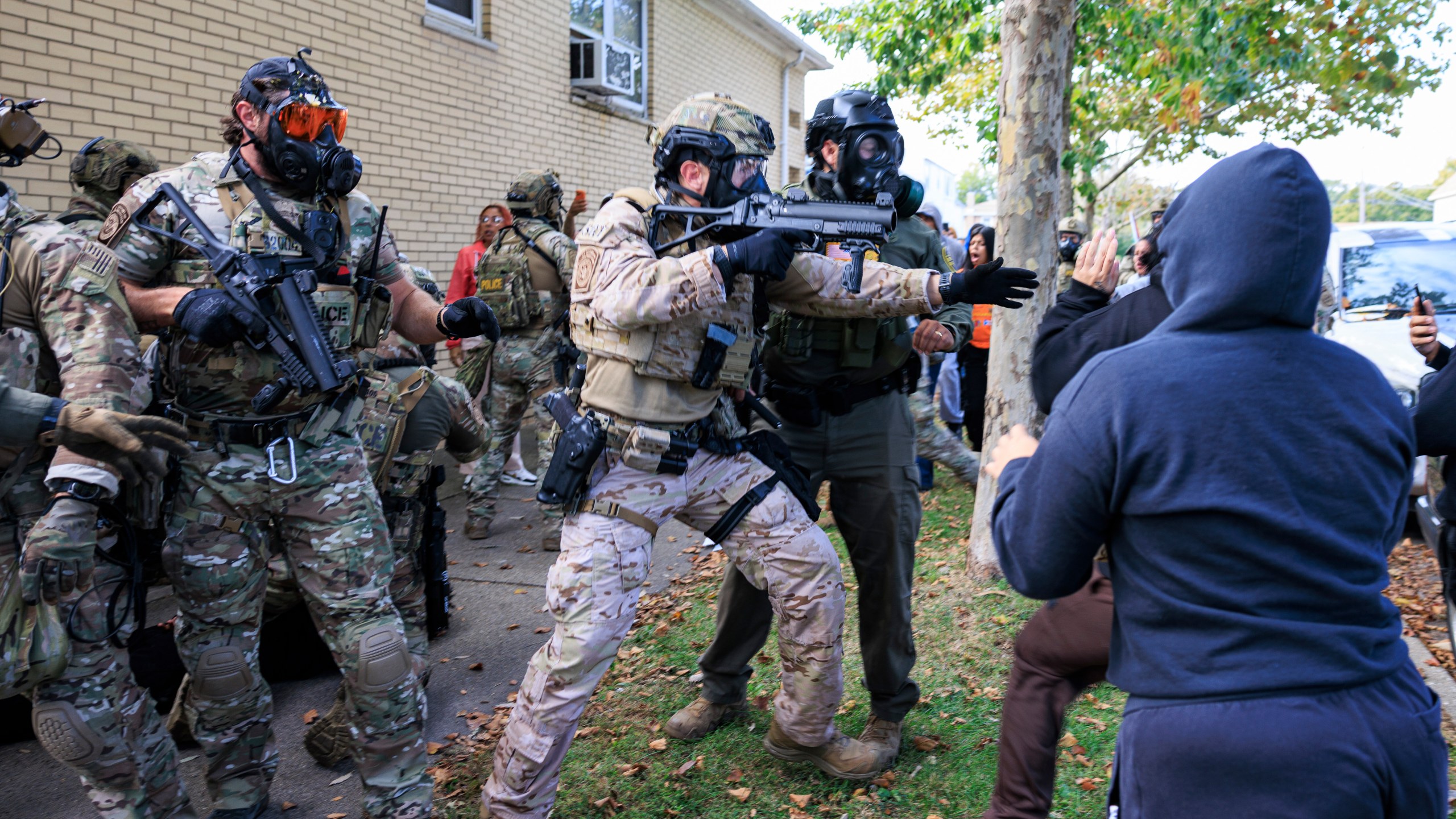 Government officials push back protesters in Chicago, Tuesday, Oct. 14, 2025. (Anthony Vazquez/Chicago Sun-Times via AP)