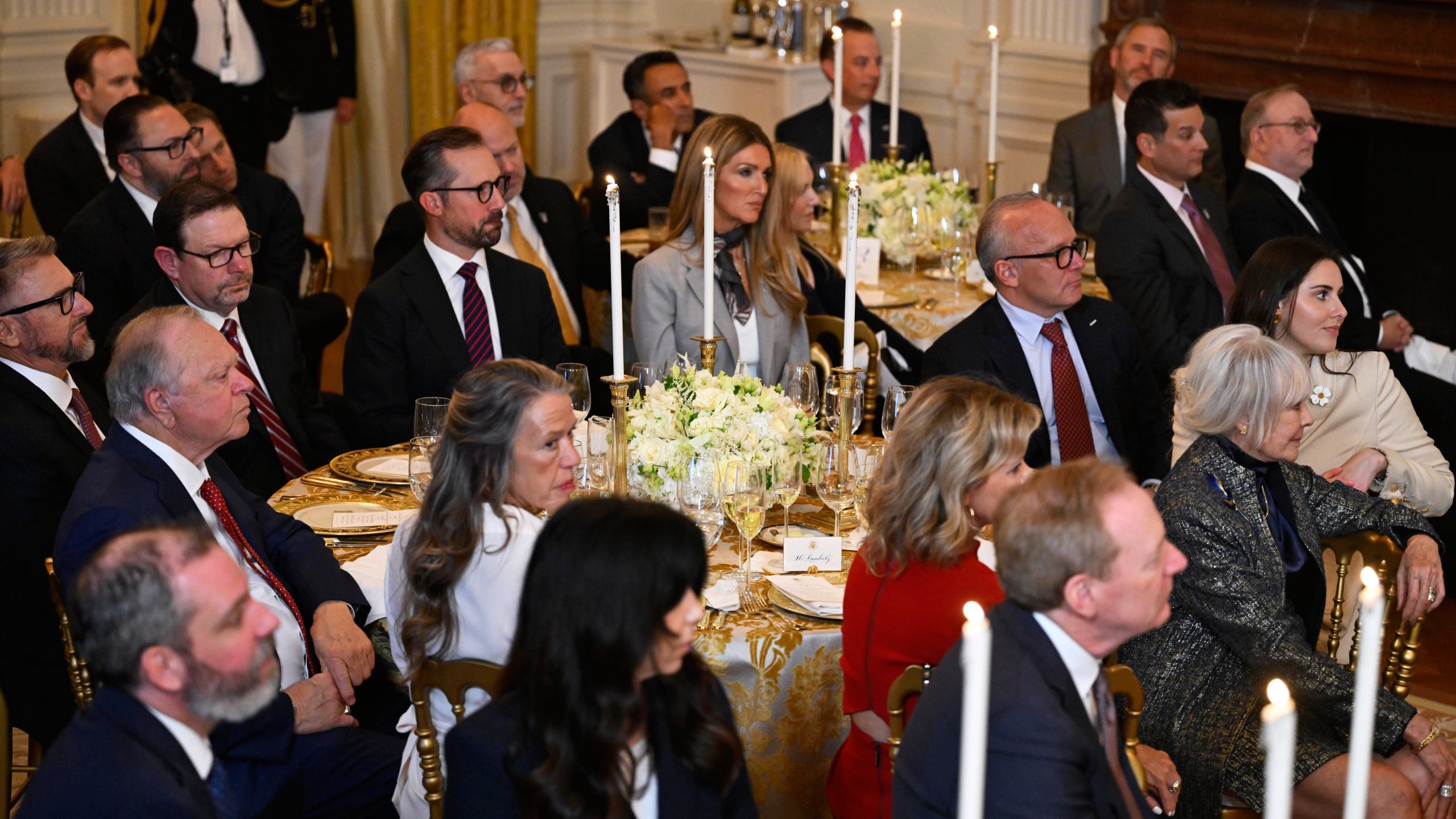 Guests listens as President Donald Trump addresses a dinner for donors who have contributed to build the new ballroom at the White House, Wednesday, Oct. 15, 2025, in Washington. (AP Photo/John McDonnell)