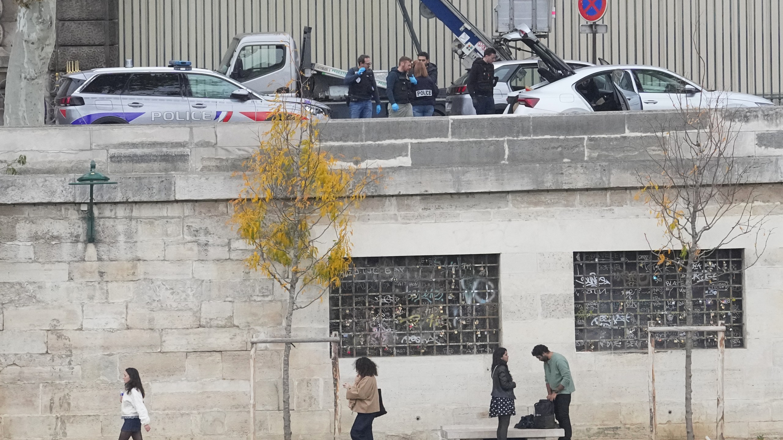 Police officers work by a basket lift used by thieves at the Louvre museum after a robbery Sunday, Oct. 19, 2025 in Paris. (AP Photo/Thibault Camus)
