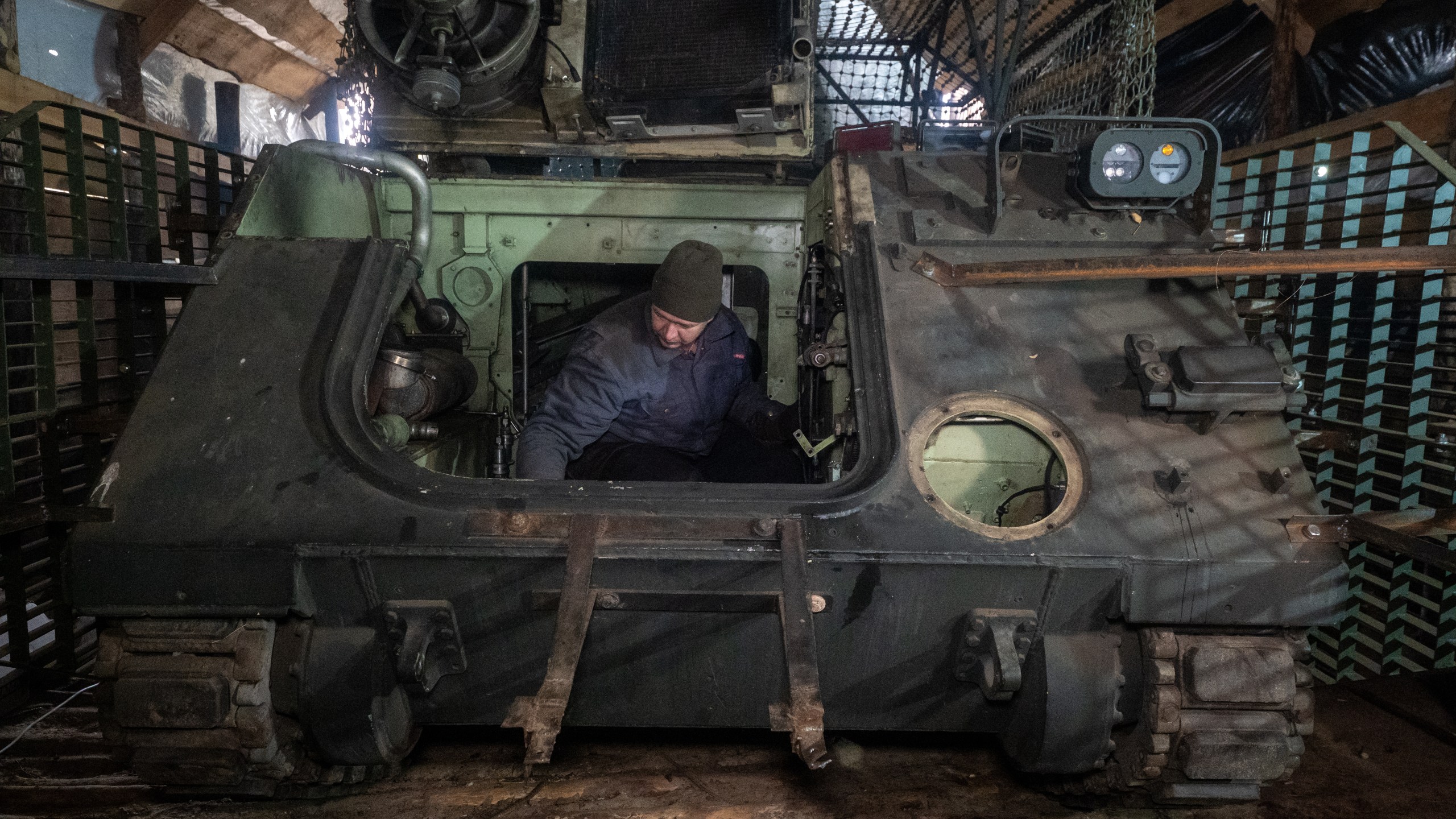 Ukrainian soldiers from repair and recovery battalion of the 57th separate brigade repair an armoured personnel carrier (APC) outskirts Kharkiv, Ukraine, Monday, Oct. 20, 2025. (AP Photo/Andrii Marienko)