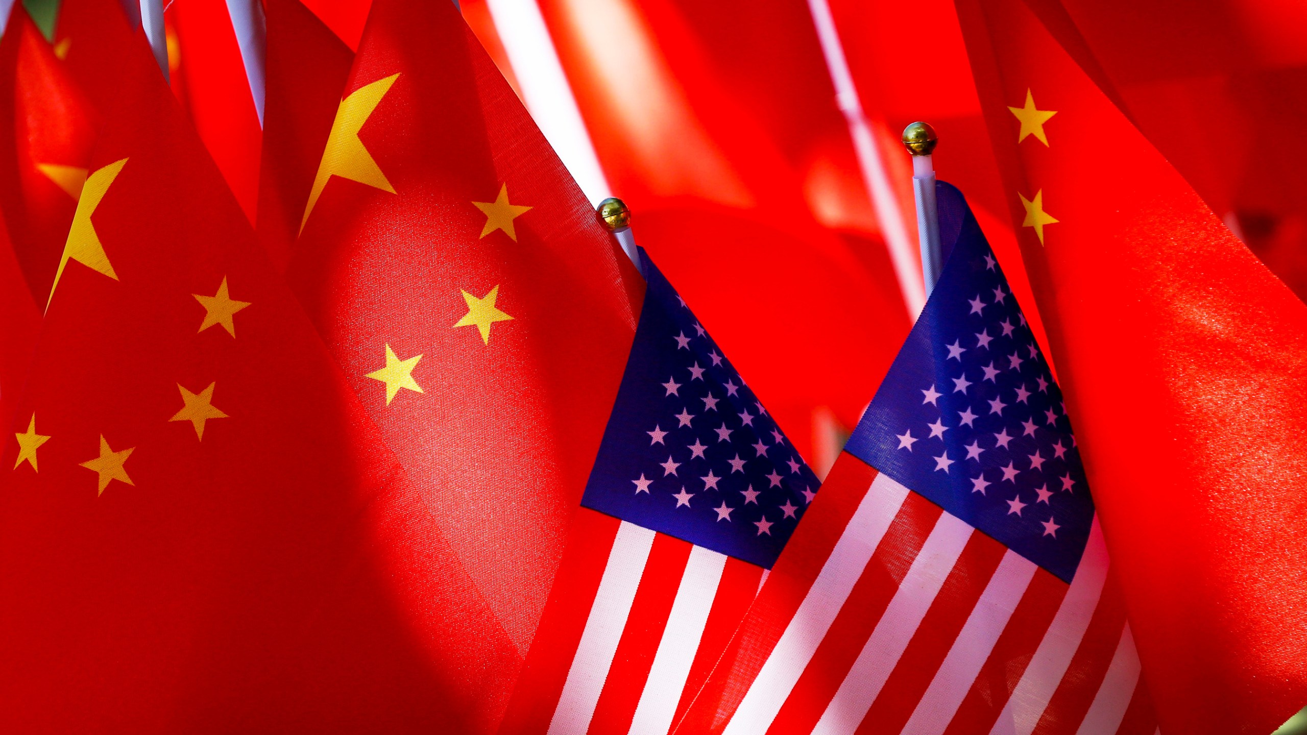 FILE - American flags are displayed with Chinese flags on Sept. 16, 2018, in Beijing. (AP Photo/Andy Wong, File)