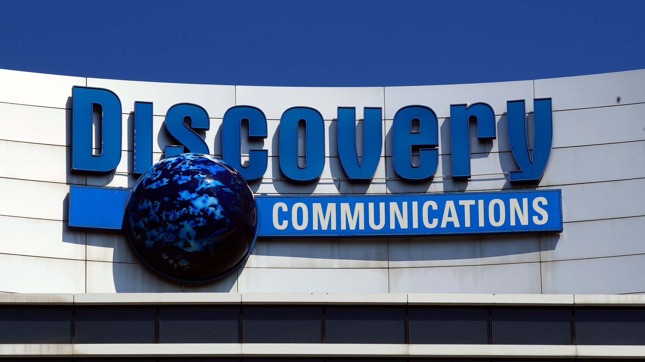 FILE - The Discovery Communications logo atop its headquarters in Silver Spring, Md, July 31, 2017. (AP Photo/Manuel Balce Ceneta, File)
