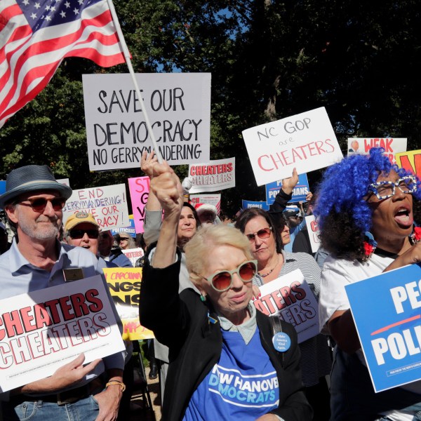 Attendees cheer during a rally protesting a proposed redistricting map in North Carolina