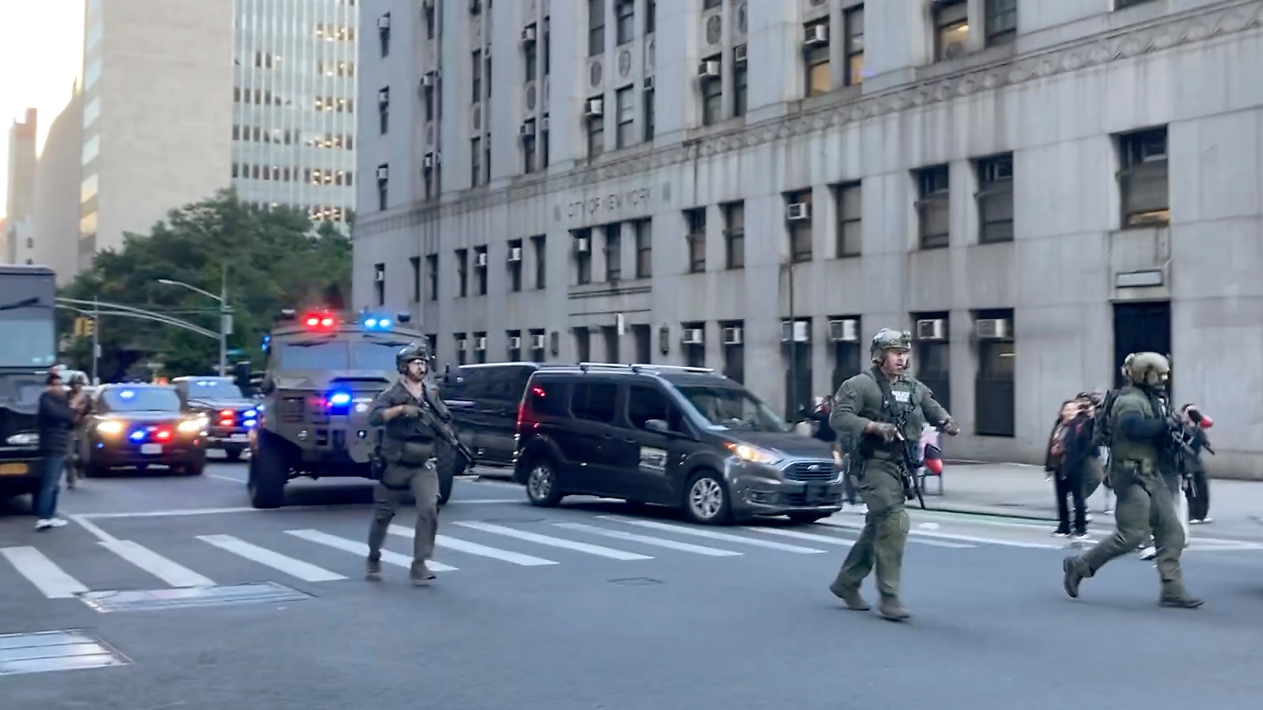 Federal agents walk down Lafayette Street as demonstrators follow along after an immigration sweep on Canal Street through Chinatown, Tuesday, Oct. 21, 2025, in New York. (AP Photo/Jake Offenhartz)
