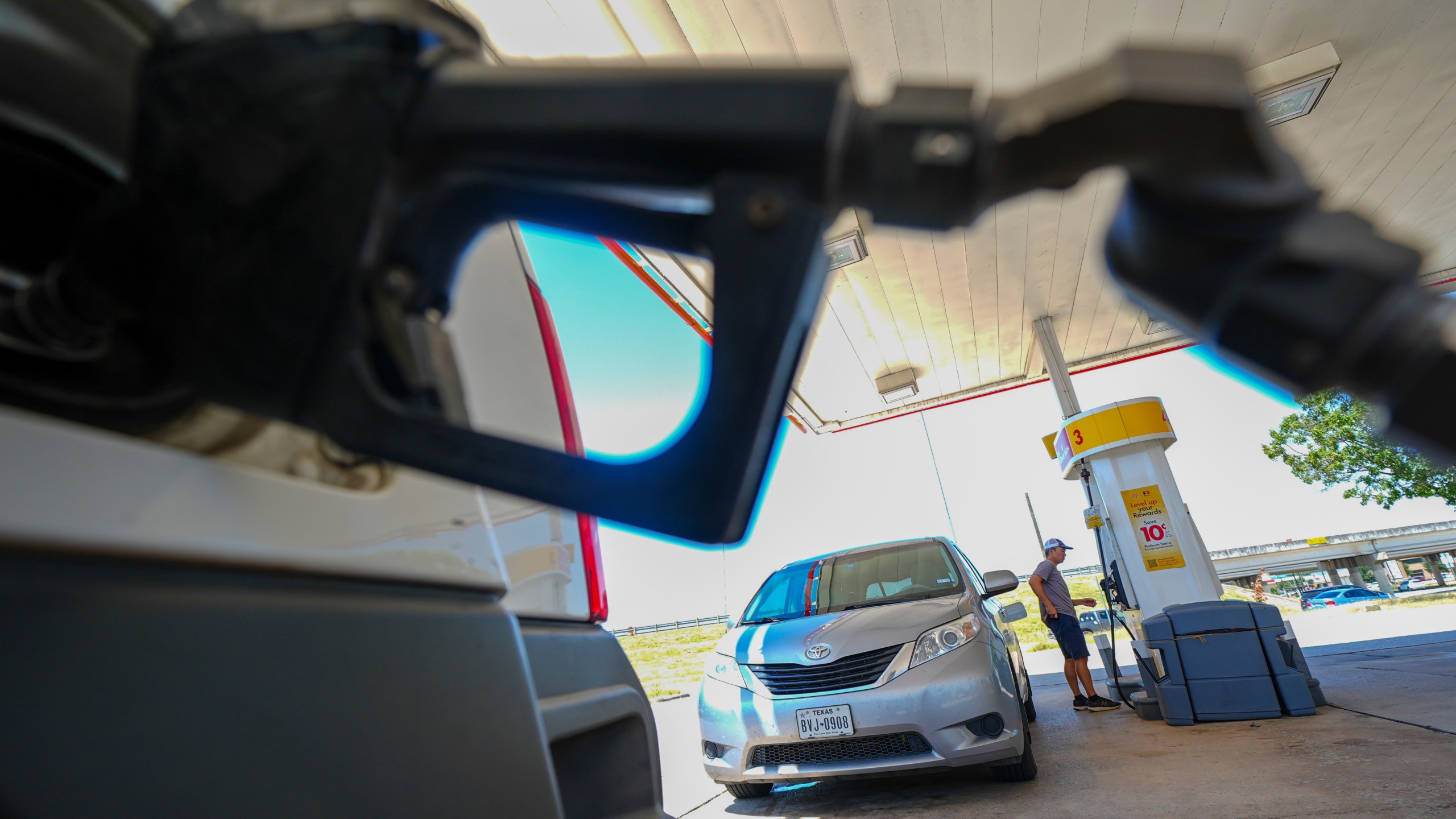 FILE - A person pays for fuel at a Shell gas station, Tuesday, July 29, 2025, in Arlington, Texas. (AP Photo/Julio Cortez, File)