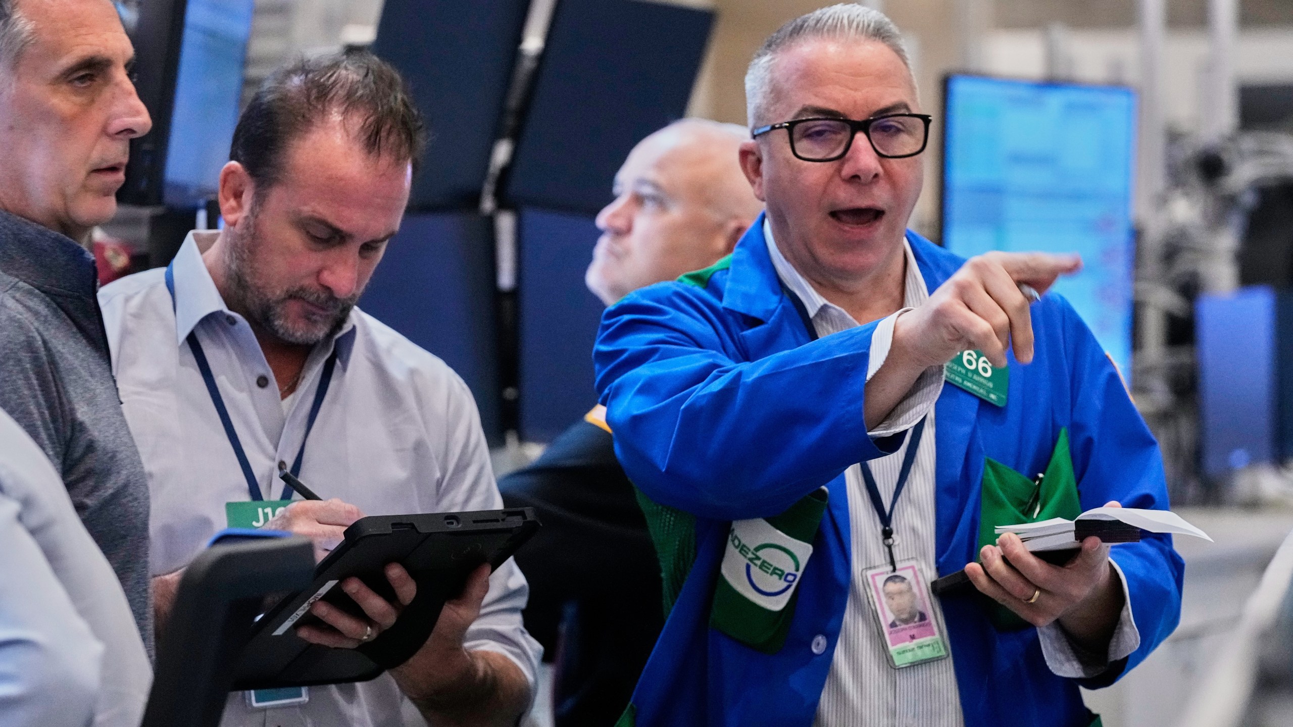 Options traders Joseph Arrigo, right, works on the floor of the New York Stock Exchange, Monday, Oct. 20, 2025. (AP Photo/Richard Drew)