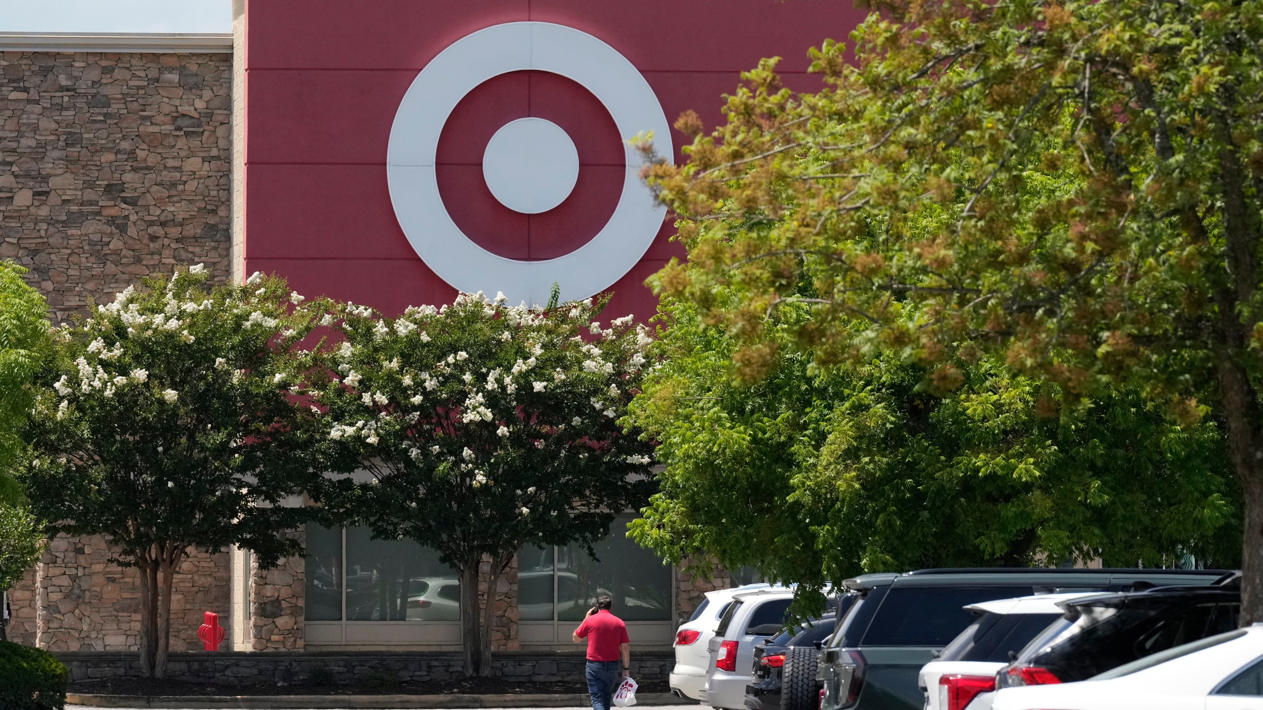 FILE - A person walks towards a Target store, July 15, 2025, in Nashville, Tenn. (AP Photo/George Walker IV, File)