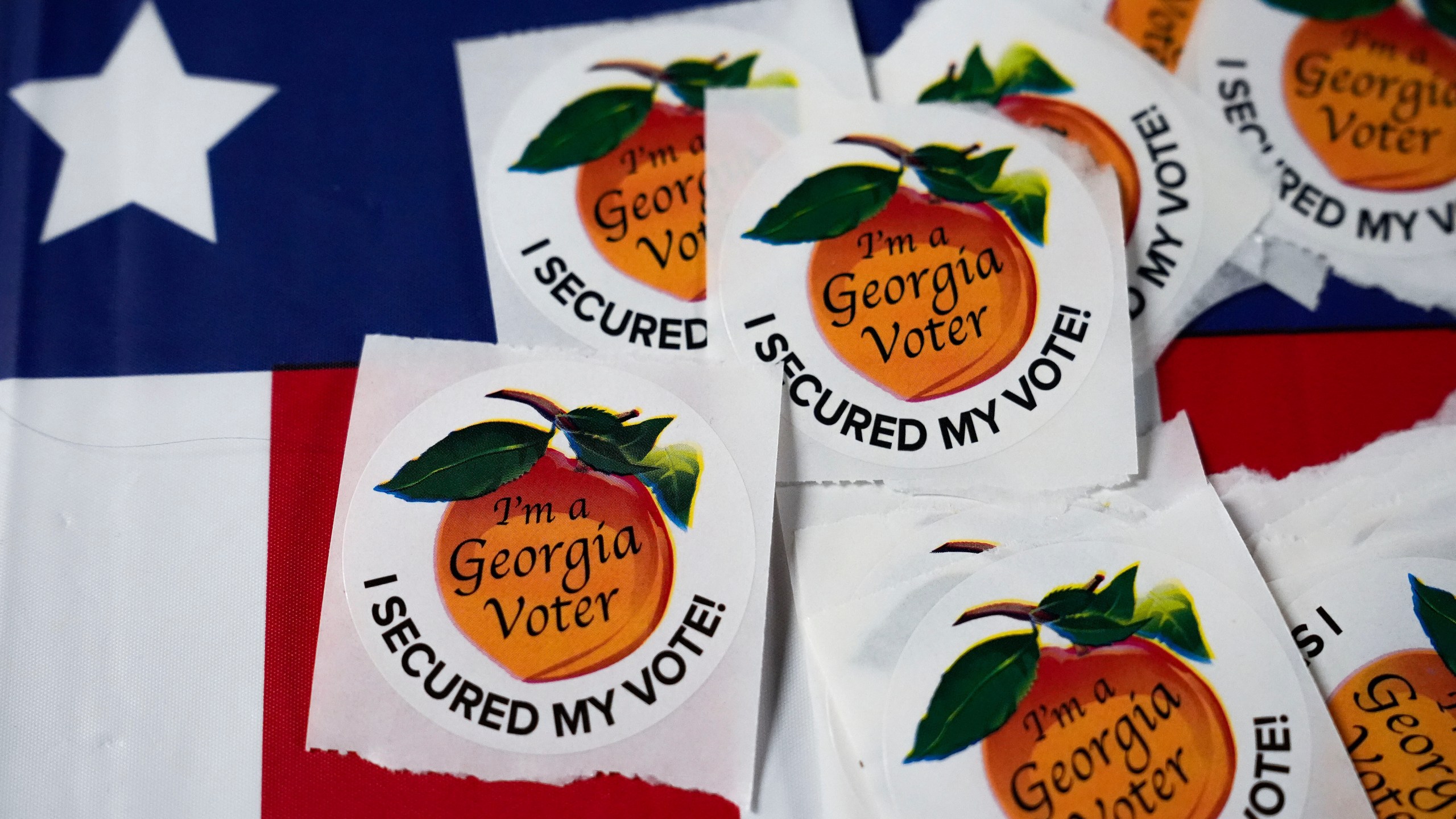 FILE - Stickers lay on a table inside a polling place, Nov. 5, 2024, in Atlanta. (AP Photo/Brynn Anderson, File)