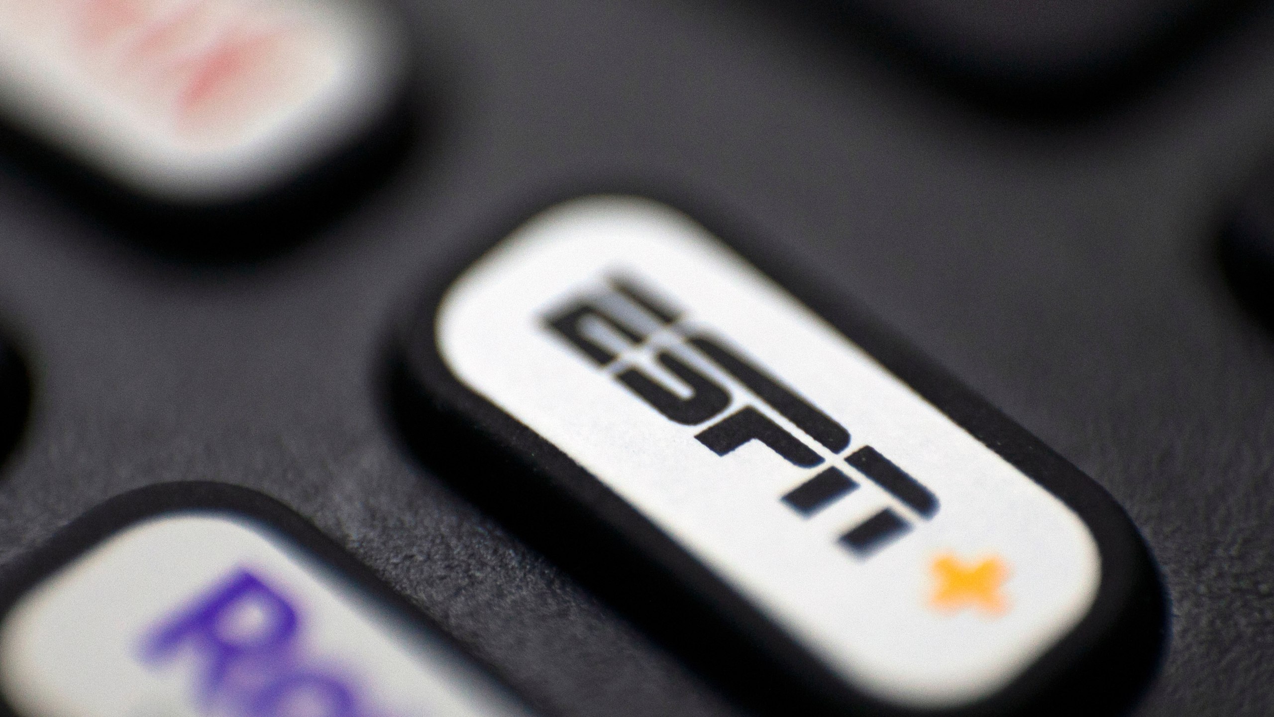 FILE — This Aug. 13, 2020 file photo shows a logo for ESPN on a remote control, in Portland, Ore. (AP Photo/Jenny Kane, FIle)