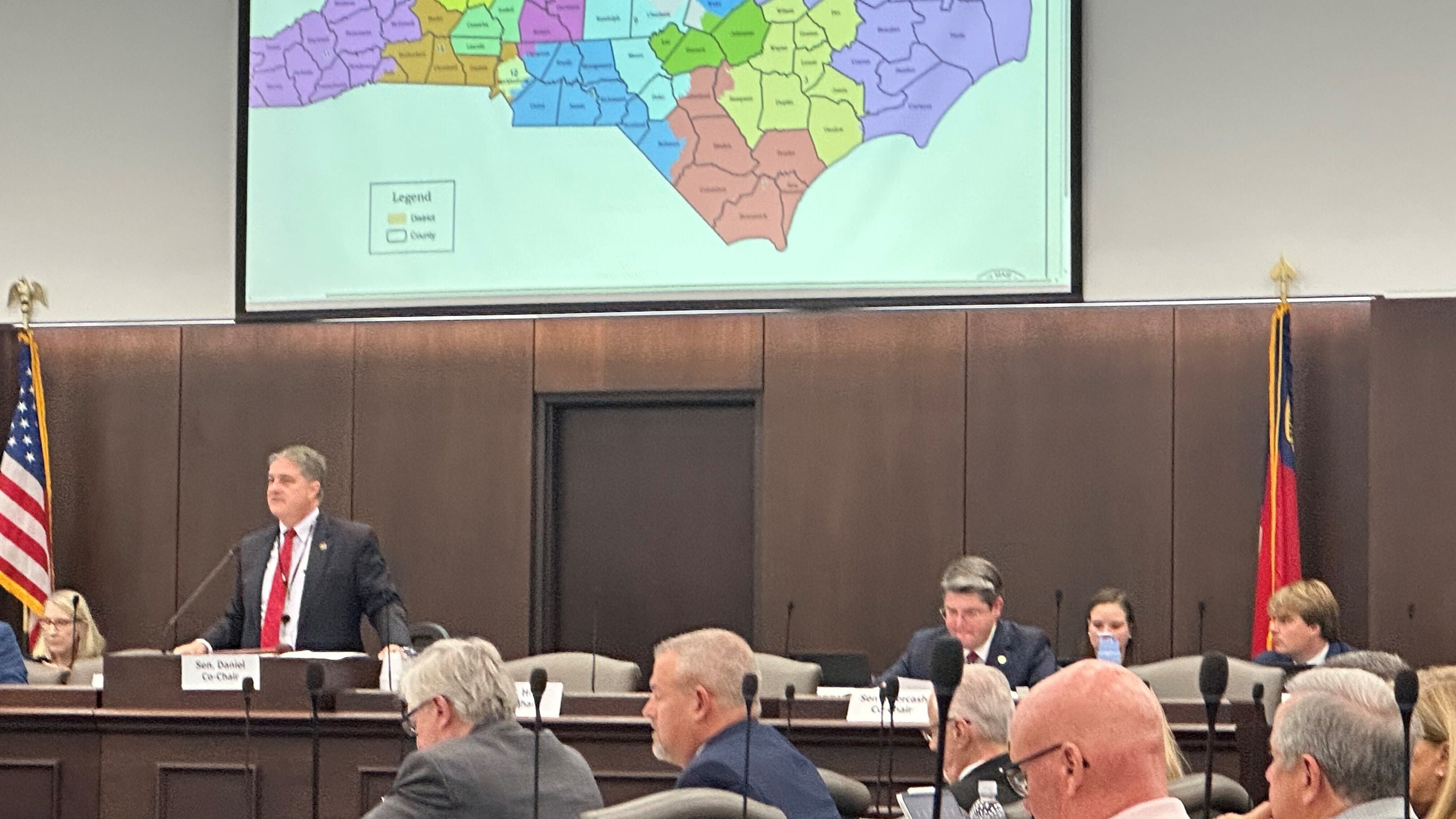 North Carolina state Sen. Warren Daniel, R-Burke (left and standing), presides over the Senate Committee on Elections while it considers legislation to redraw the state's U.S. House district map at the Legislative Office Building in Raleigh N.C., Monday, Oct. 20, 2025. (AP Photo/Gary D. Robertson)