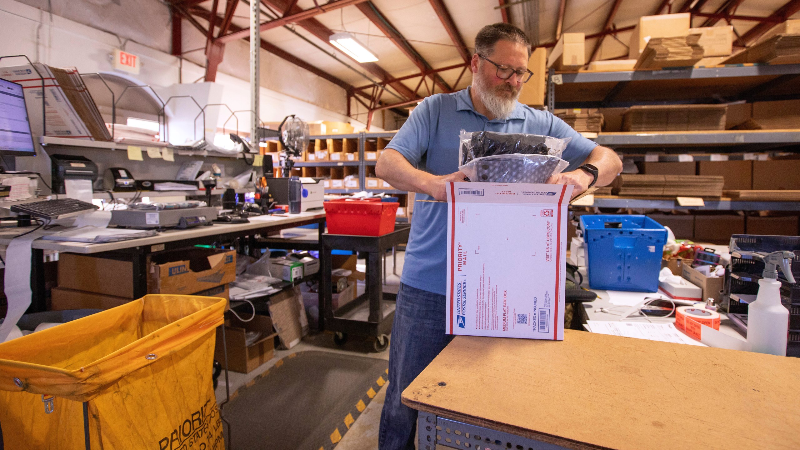 Terry Precision Cycling warehouse manager Luke Tremble packs orders at the company’s warehouse in Burlington, Vt., Tuesday, Oct. 28, 2025. (AP Photo/Amanda Swinhart)